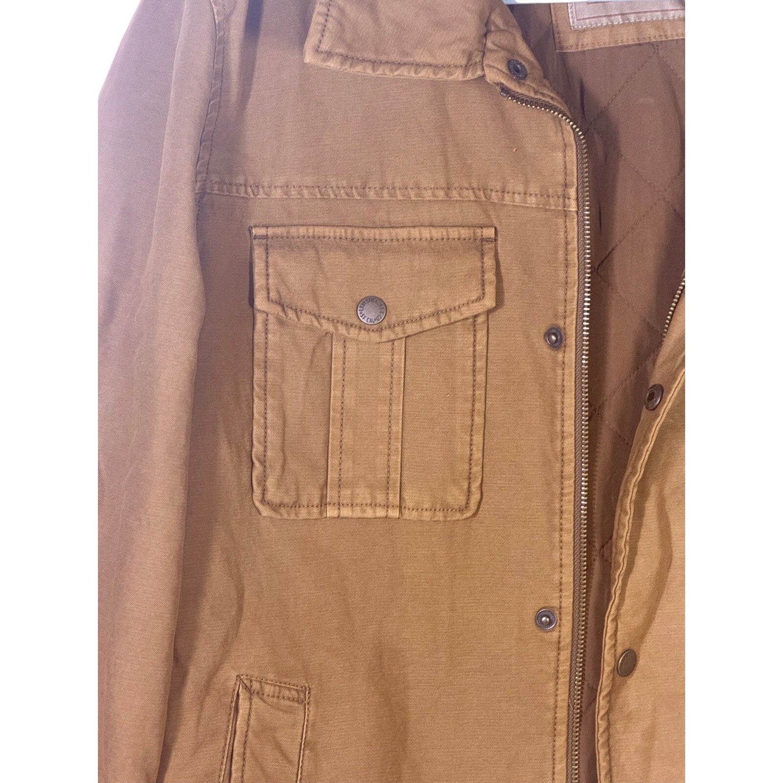 Levi’s men's tan canvas quilted utility field jacket, size medium, with multiple front pockets and quilted lining.