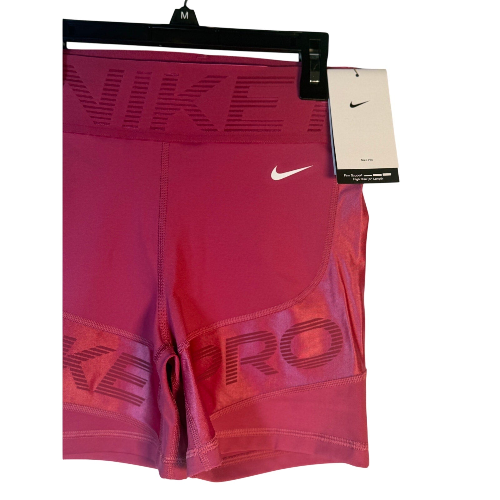 Nike Pro high-rise training shorts for women in berry color, featuring a 5-inch inseam and firm support, size large.