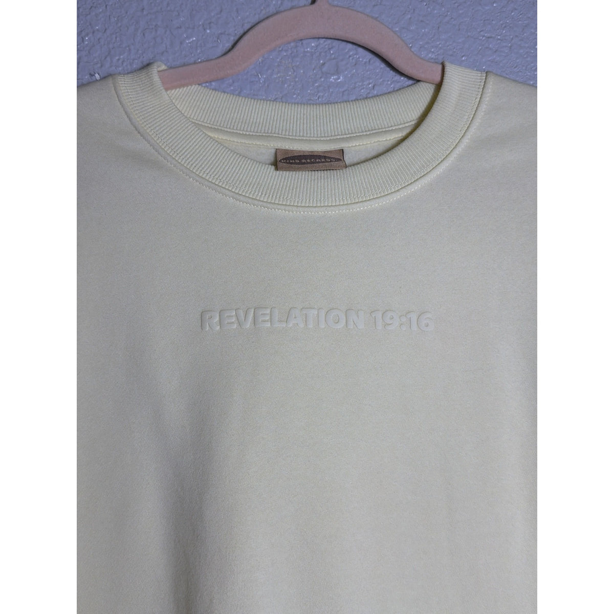 Yellow crewneck sweatshirt for women featuring a Christian message, from Kind Regards, with Revelation 19:16 Jesus is King design.
