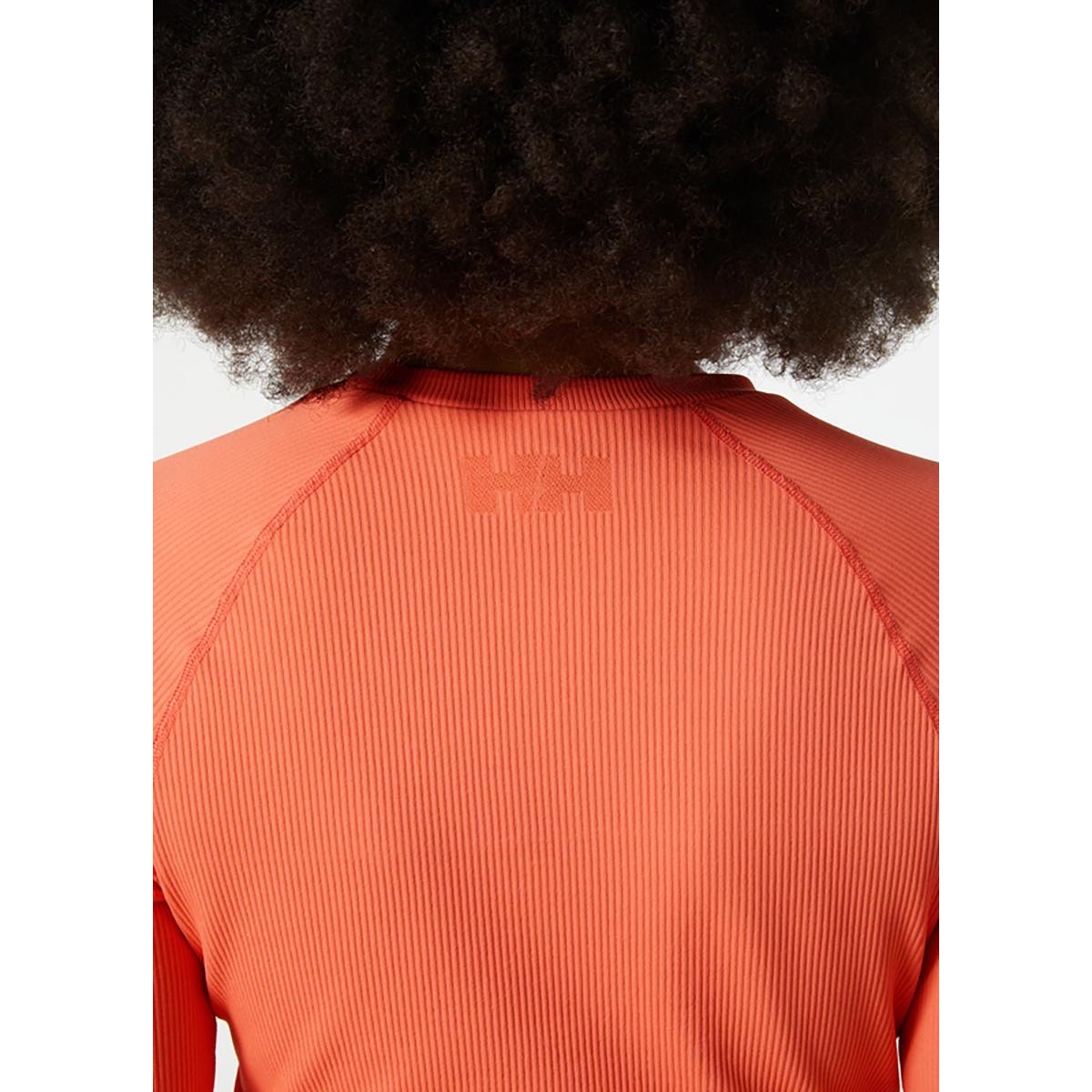 Youth Helly Hansen peach long sleeve T-shirt in size large, featuring the brand logo and soft fabric, front view.