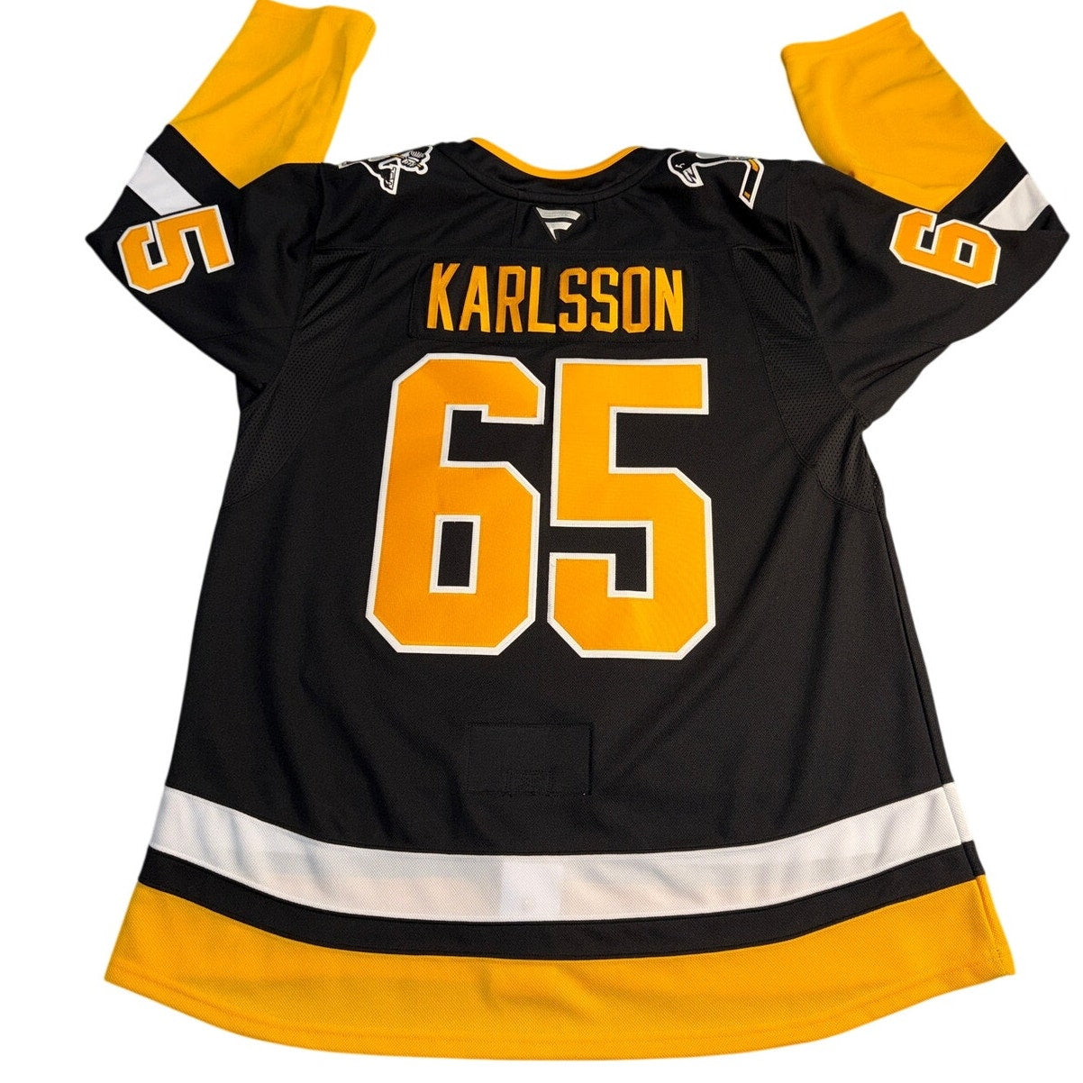 Fanatics Pittsburgh Penguins Erik Karlsson #65 NHL premium hockey jersey in size 56 displayed on a hanger.