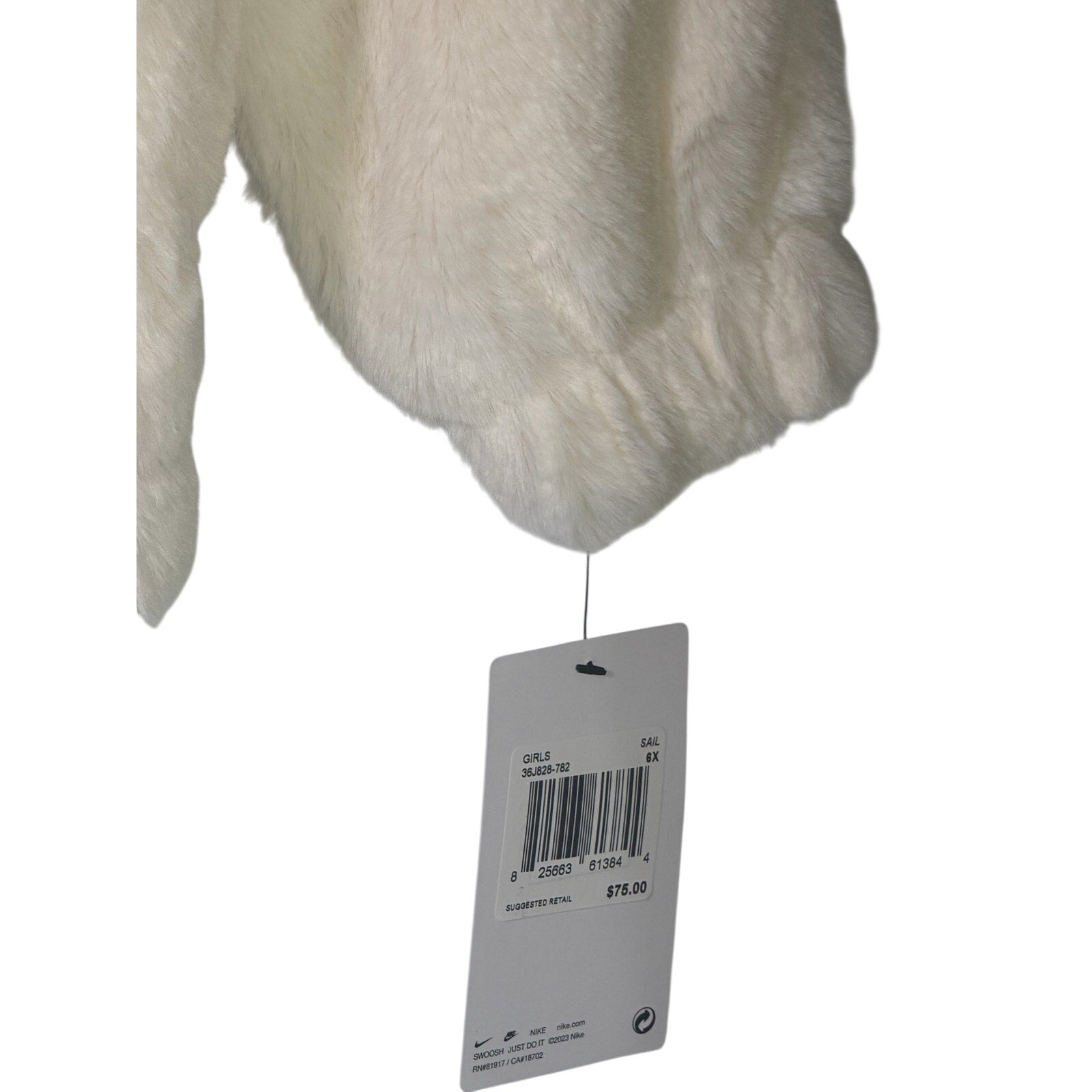 Nike girls' faux fur zip-up jacket in cream and black, size 6X, featuring an oversized swoosh logo, new with tags.