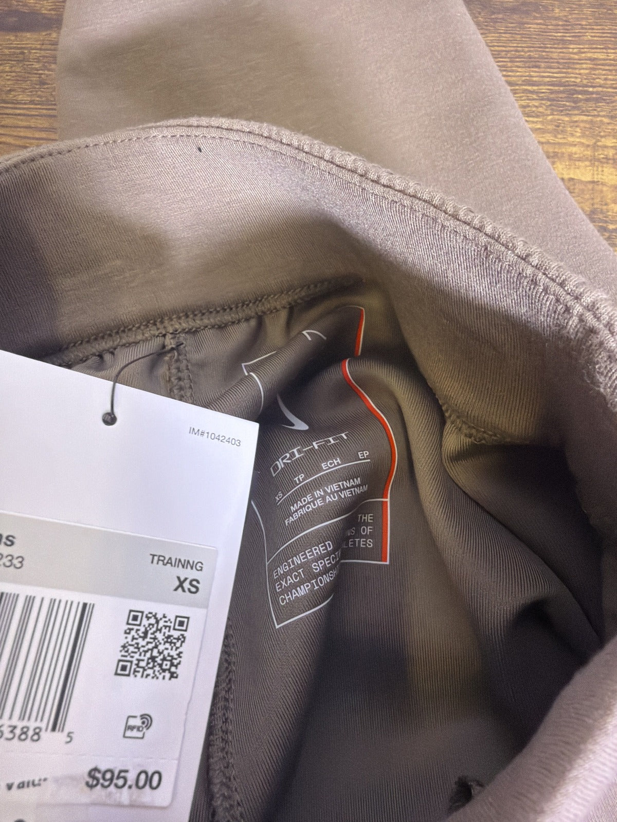 Nike 24.7 Dri-FIT women's jogger pants in tan taupe, XS size, showing the relaxed fit and soft fabric material.