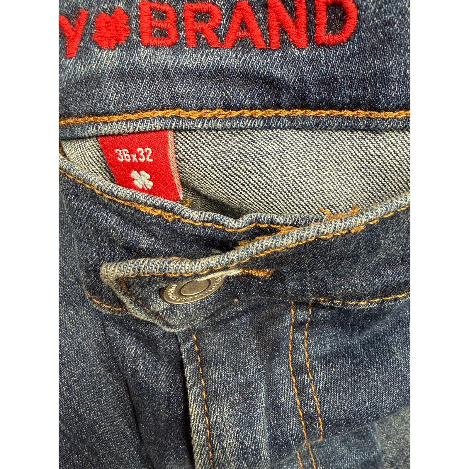 Lucky Brand men's blue denim jeans, size 36x32, medium wash straight leg pants, displayed on a hanger.