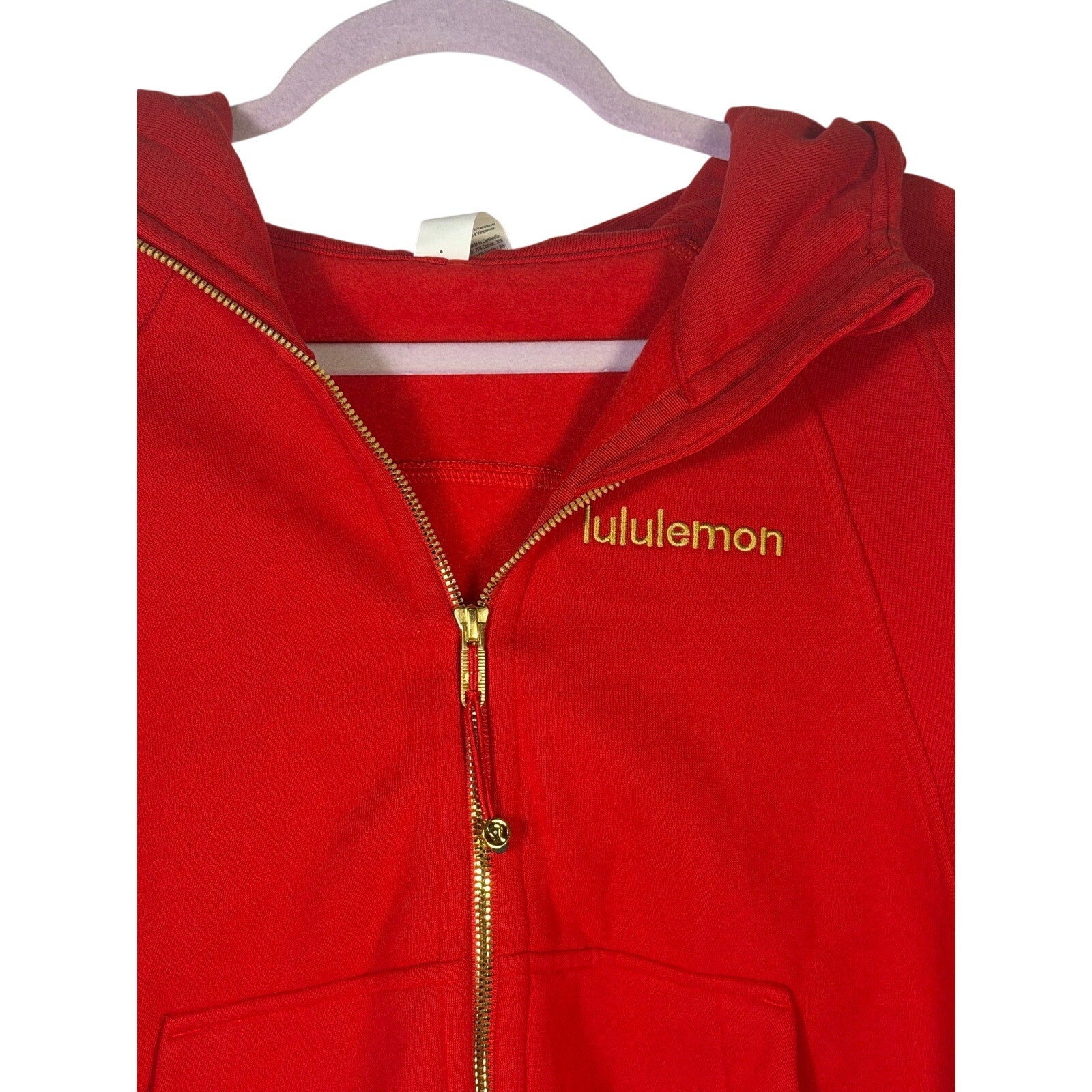 Lululemon women's red scuba oversized full zip hoodie, size M/L, with hood and front pockets, shown on a hanger.