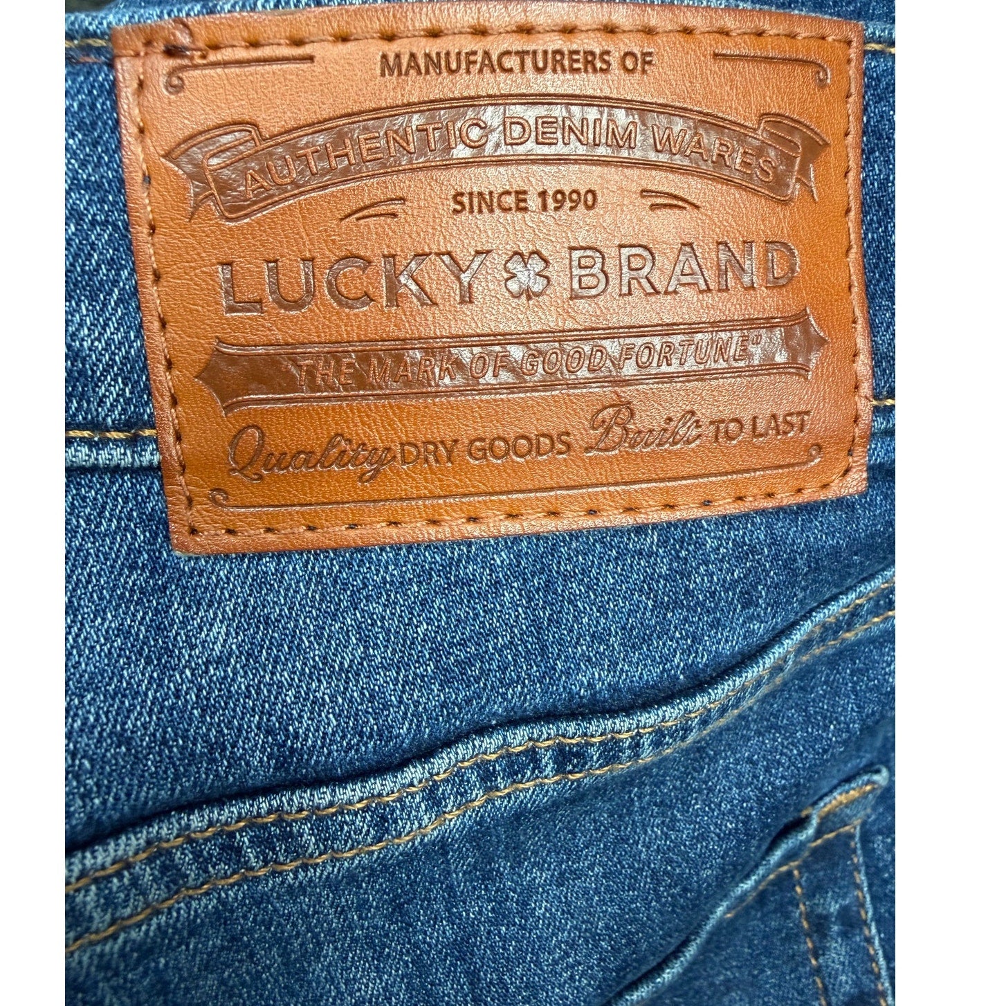 Lucky Brand men’s blue denim jeans, size 36x32, medium wash, straight leg pants displayed on a hanger.