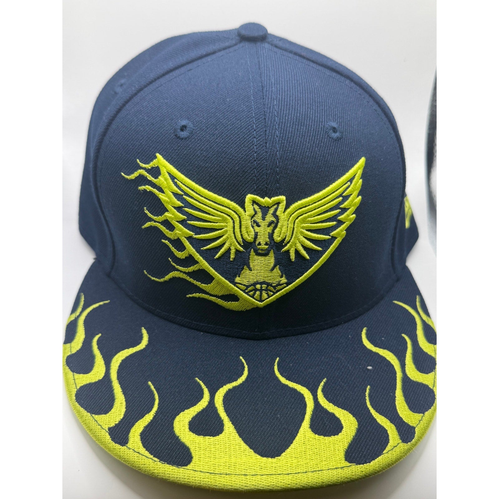 New Era Dallas Wings WNBA snapback hat in navy with neon yellow flame-brim design, one size fits most