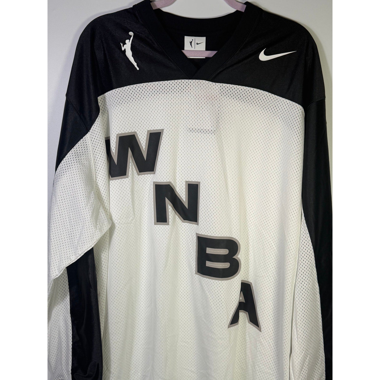 Nike x NOCTA women's WNBA long sleeve jersey in white and black, size L, with tags visible on the front.