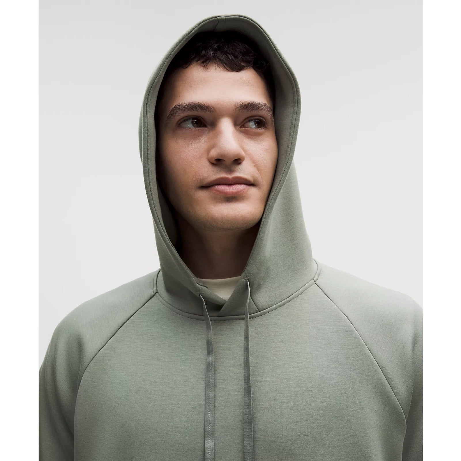 Lululemon men's green Smooth Spacer pullover hoodie with long sleeves and hood, casual athletic wear.