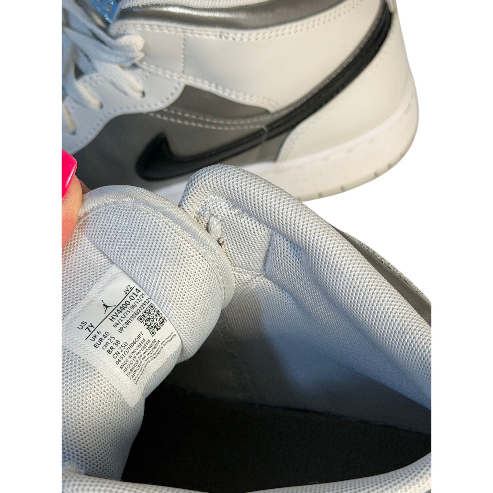 White, gray, and black Air Jordan 1 Mid GS sneakers for youth size 7Y, featuring classic Jordan design and style.
