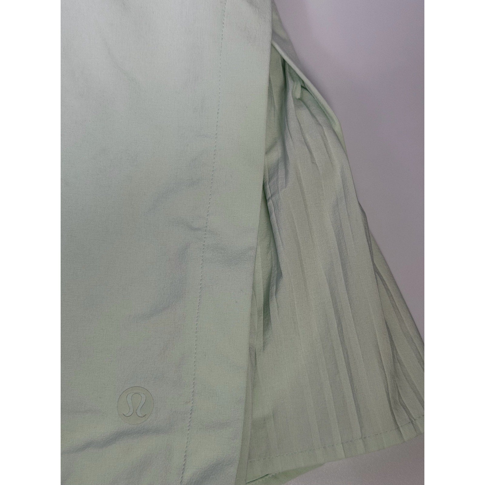 Lululemon women’s light mint pleated tennis skort with built-in shorts, size 6, athletic skirt for tennis and activewear.