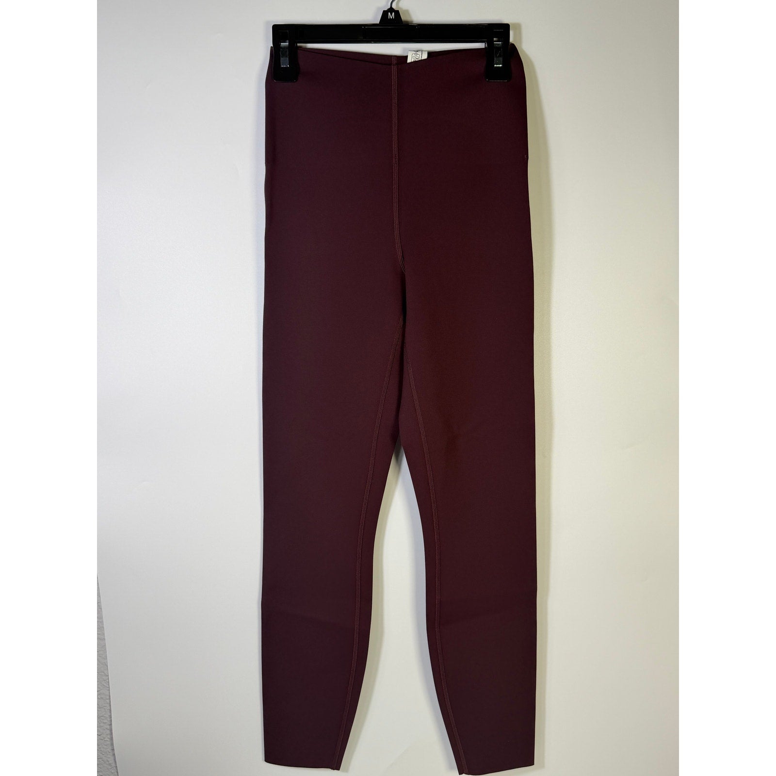 Lululemon Glow Up SHR Tight 25-inch women's leggings in size 4, close-up of black stretchy athletic leggings with subtle branding.