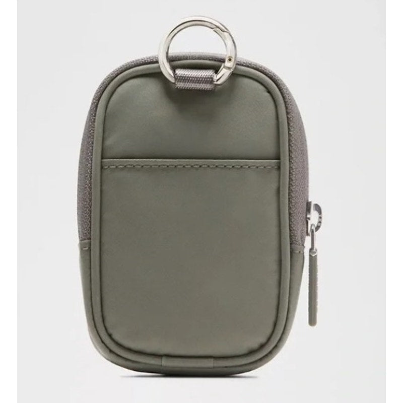 Gray and green Lululemon Clippable Nano Pouch handbag with a zipper, showing its compact design and brand logo.