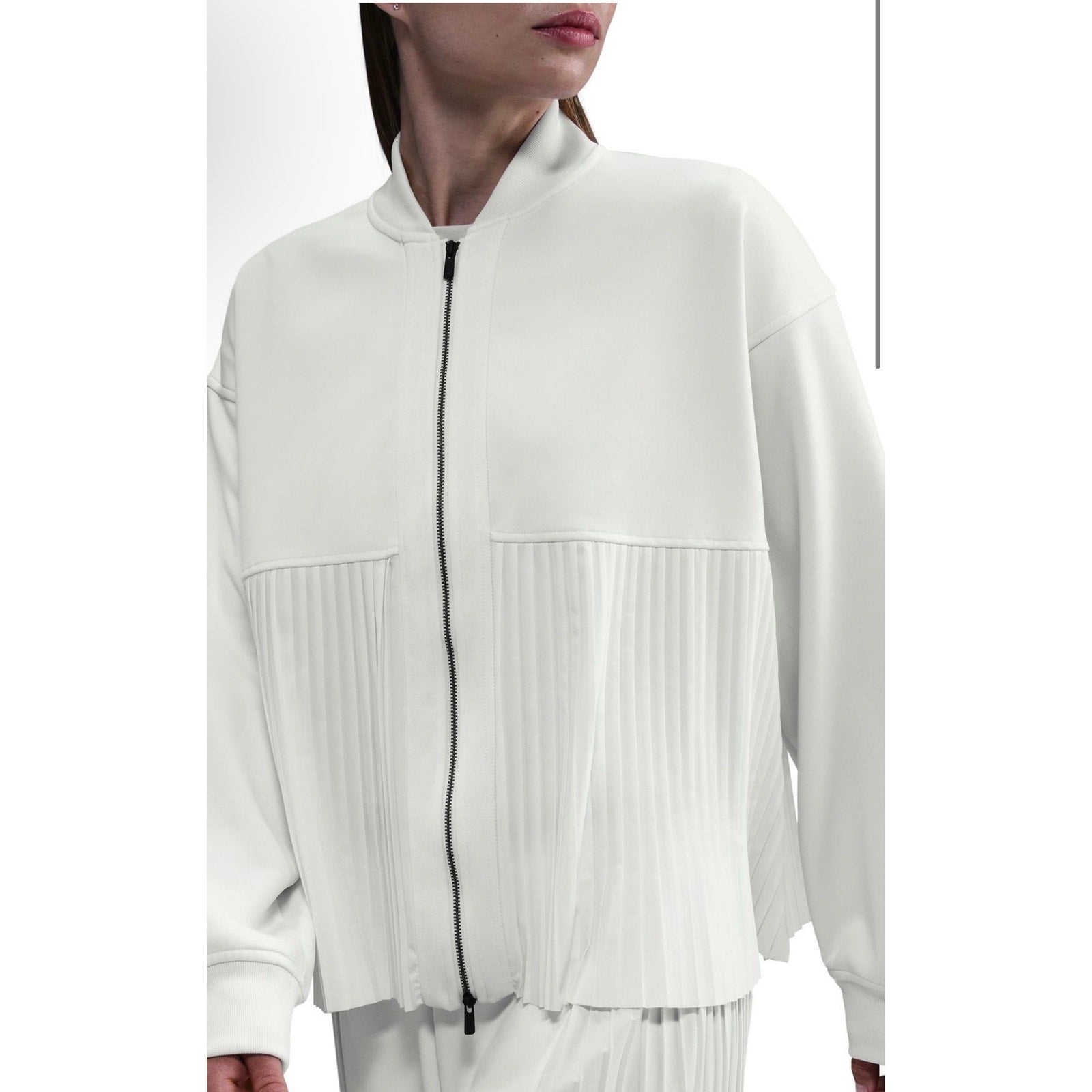 Nike Women's white pleated bomber jacket with full zipper, size M, showcasing the stylish sail-colored design and lightweight fabric.