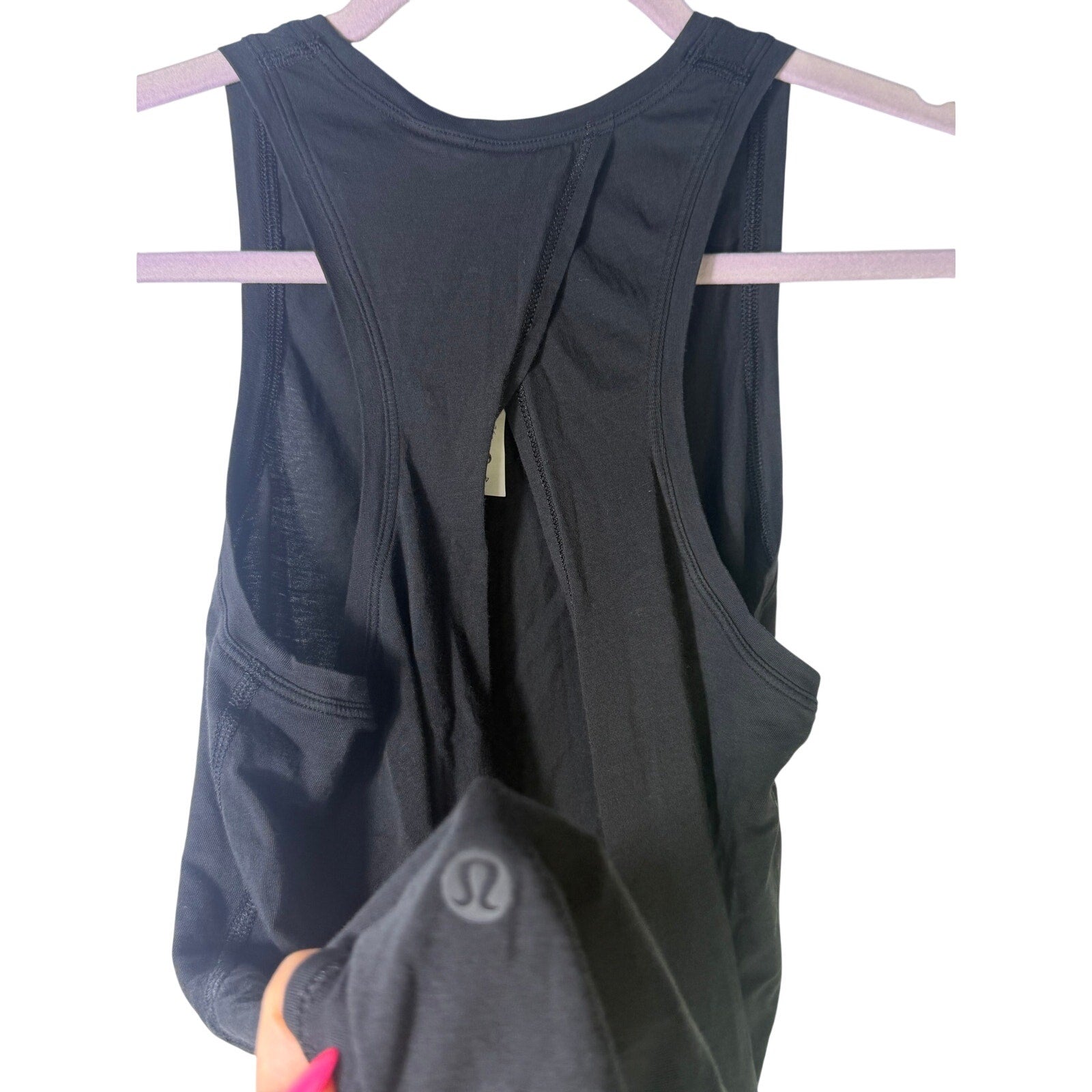 Lululemon women's black high-neck open-back athletic tank top size 4, showcasing the stylish back design and fitted silhouette.