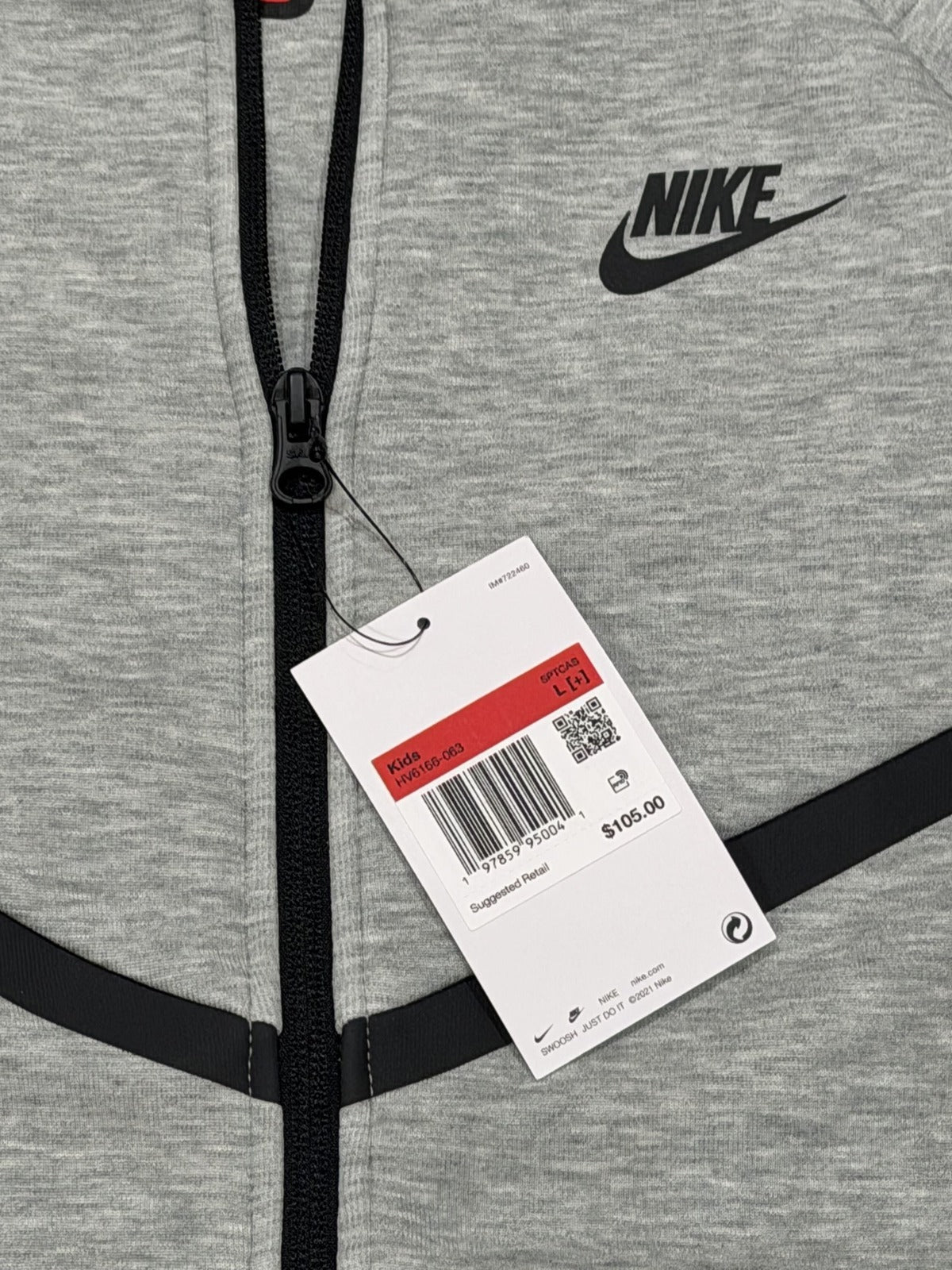 Nike Tech Fleece full-zip hoodie for big kids in dark grey heather, size L, with black accents and Nike logo.