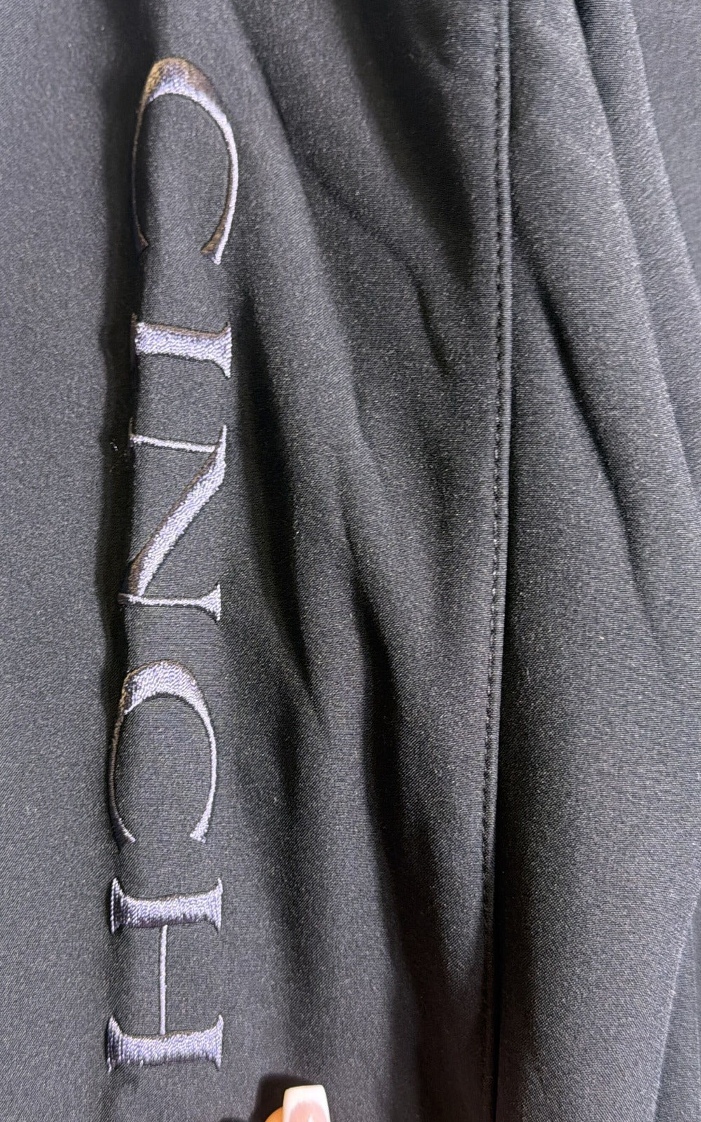Men's black Cinch bonded softshell jacket with embroidered logo, size small, shown on a hanger.