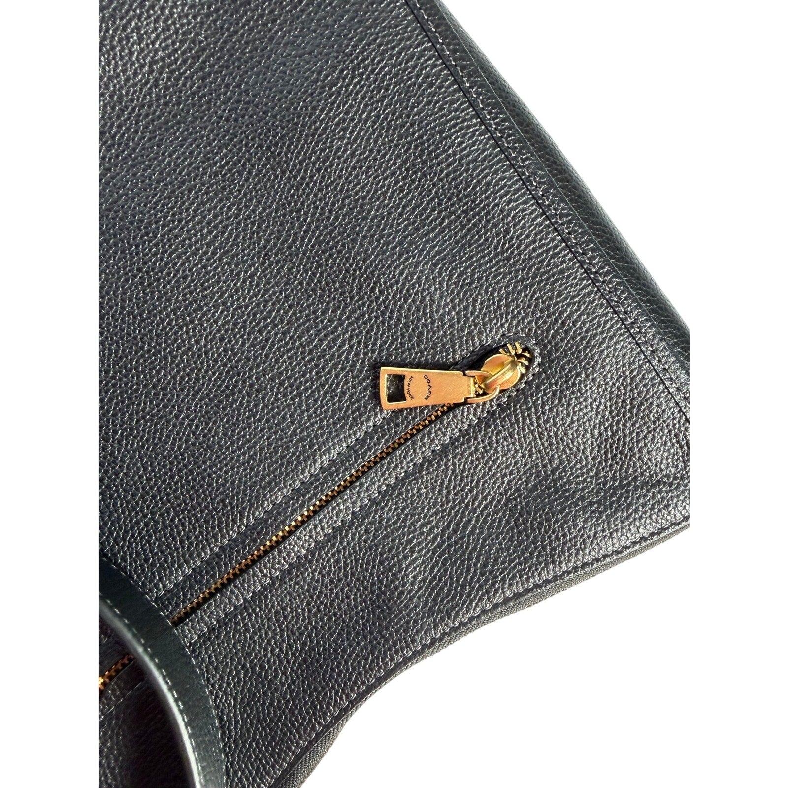 Coach women's black pebbled leather crossbody handbag with gold-tone hardware, shoulder bag with adjustable strap.