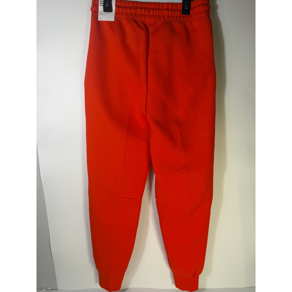 Nike Sportswear Phoenix Fleece Jogger Pants in bright orange, women's XS, showing the mid-rise fit and cozy fleece material.