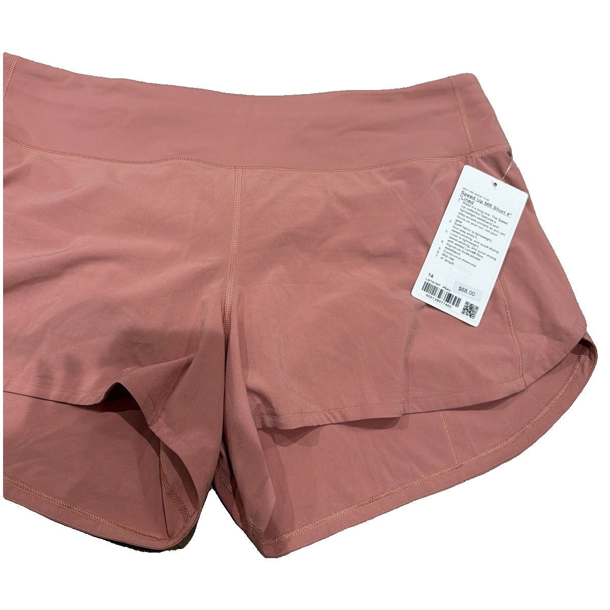Lululemon Speed Up mid-rise lined shorts in Pink Savannah, women's size 14, showing the lightweight fabric and 4-inch length.