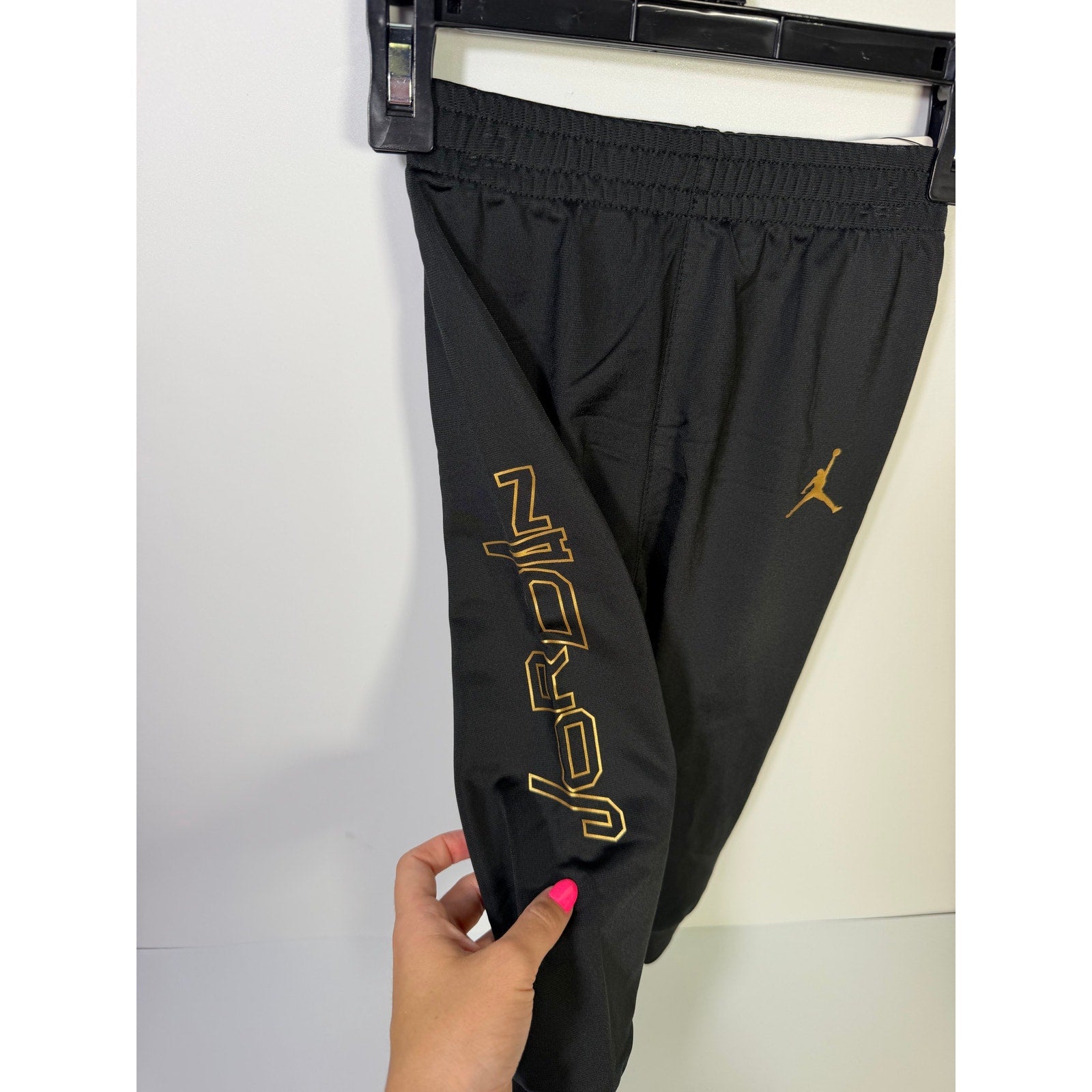 Jordan baby boys 2-piece black and gold track jacket and jogger set, size 18M, featuring sporty design and comfortable fabric.