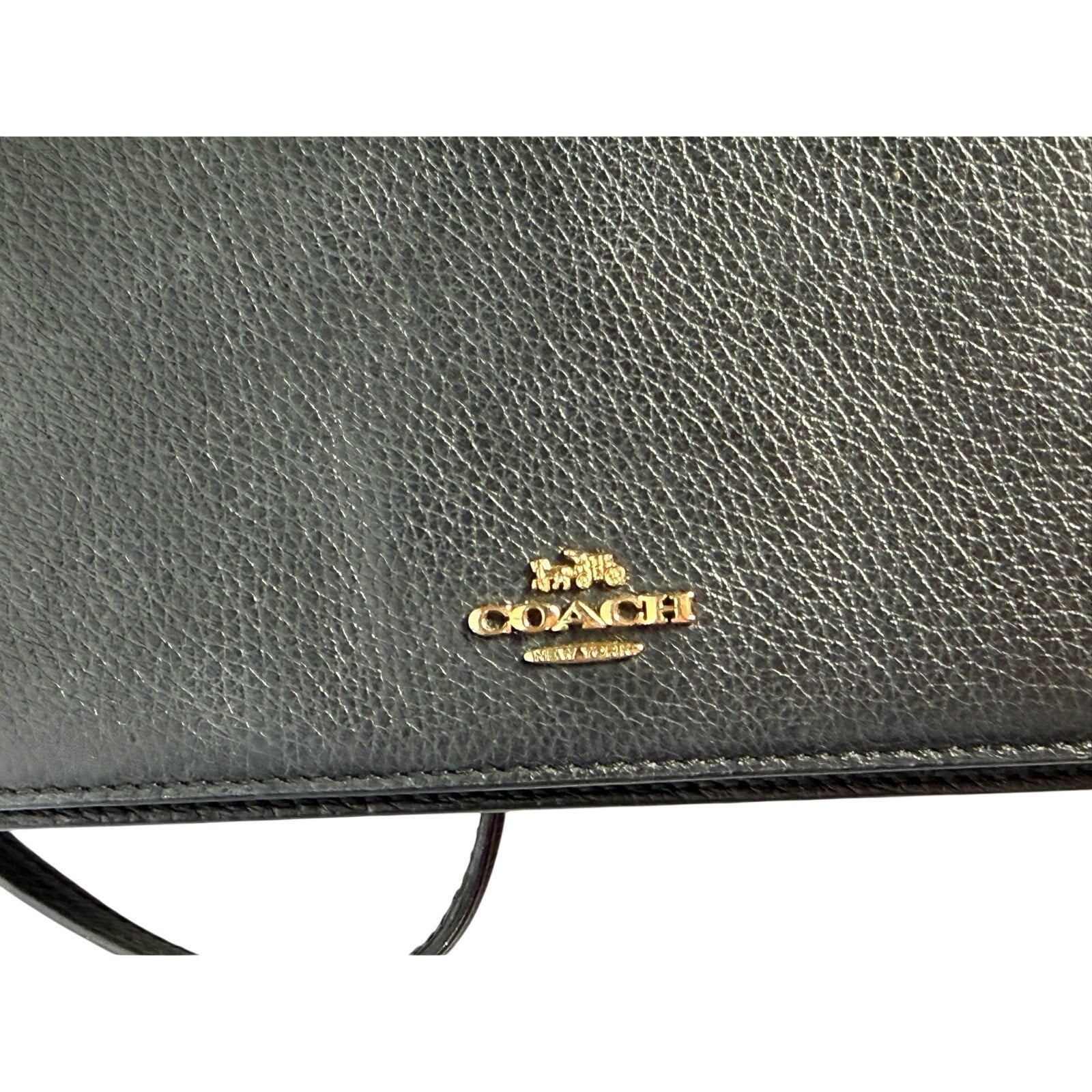 Coach women's black leather foldover crossbody wallet bag with adjustable strap and compact handbag design.