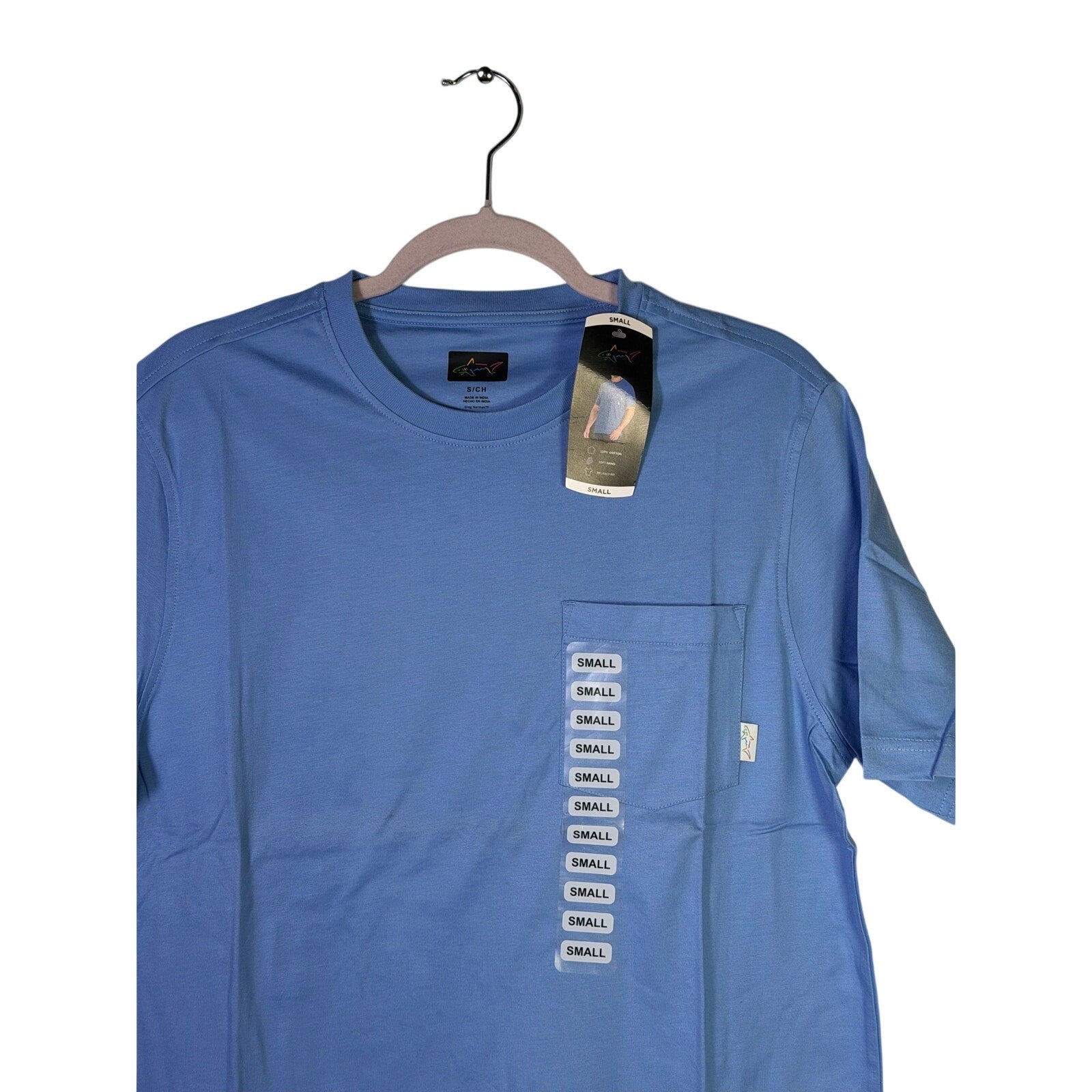 Greg Norman men's blue pocket T-shirt in relaxed fit, size small, shown flat with front view and chest pocket detail.