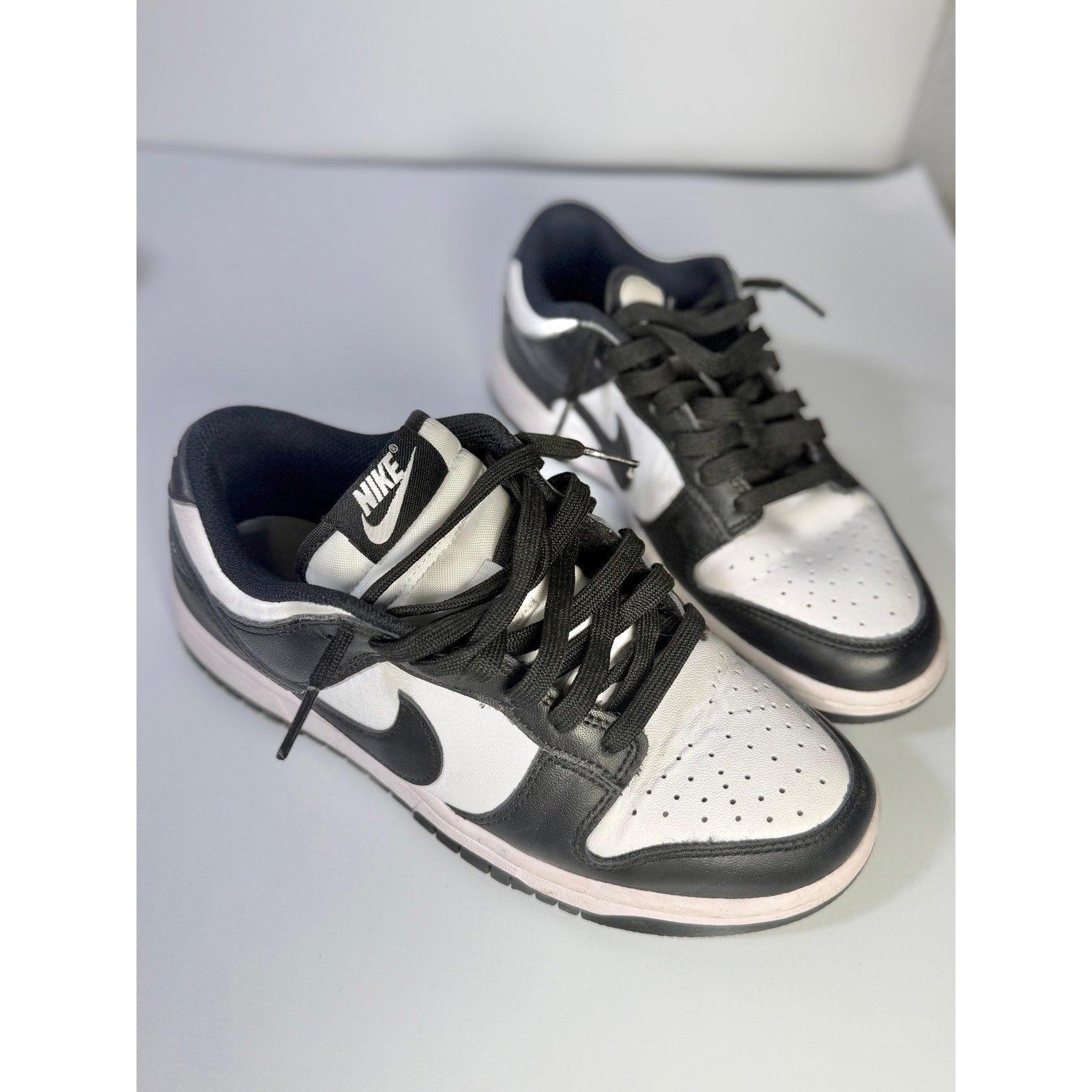Nike Dunk Low Panda youth sneakers in black and white with a low-top design, size 5Y, featuring iconic Nike branding.