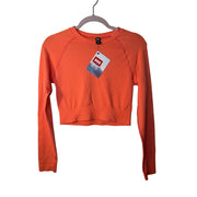 Youth Helly Hansen long sleeve T-shirt in peach, size large, featuring the brand logo on the front.