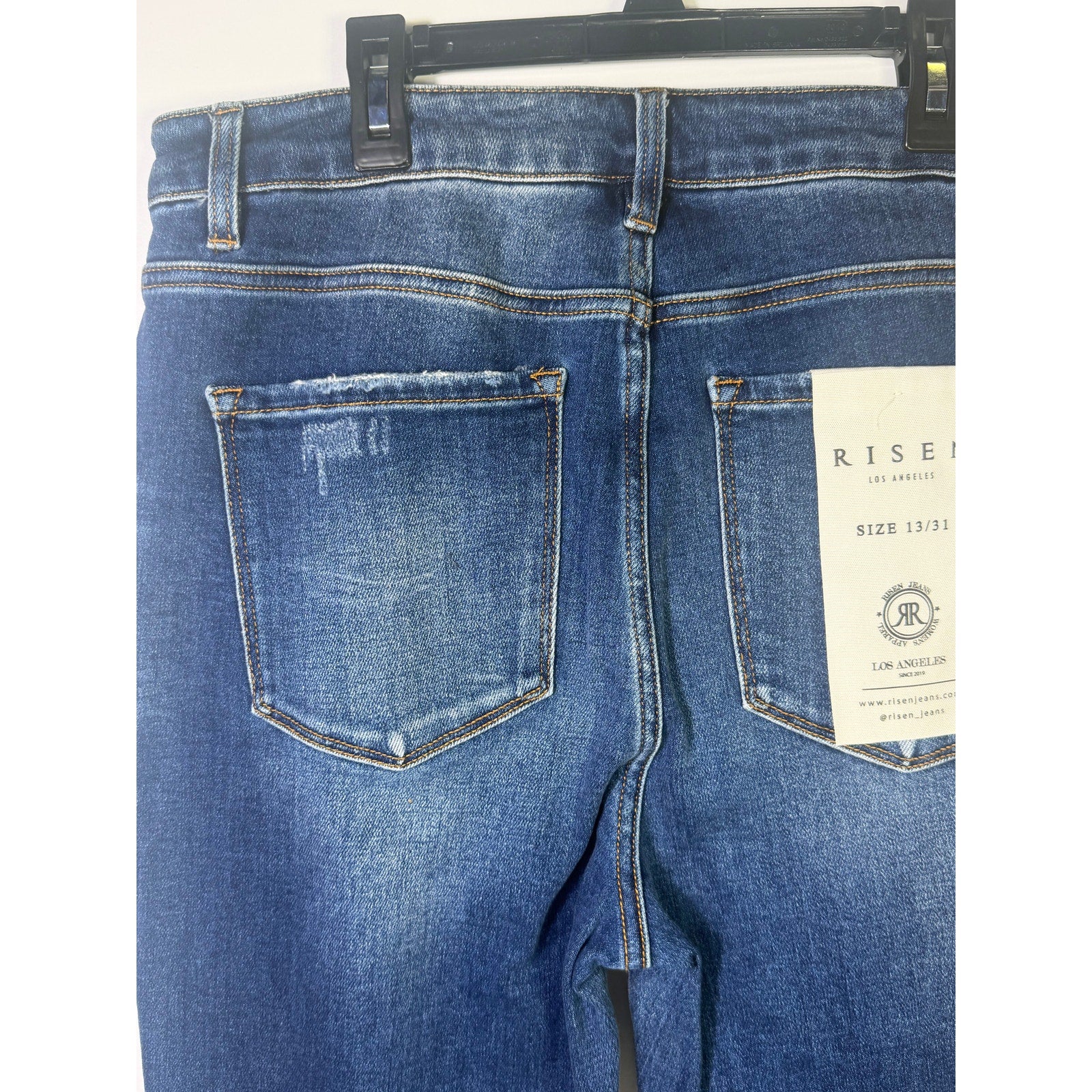 Risen Jeans women's size 13/31 dark wash distressed flare jeans with frayed hems and classic five-pocket styling.