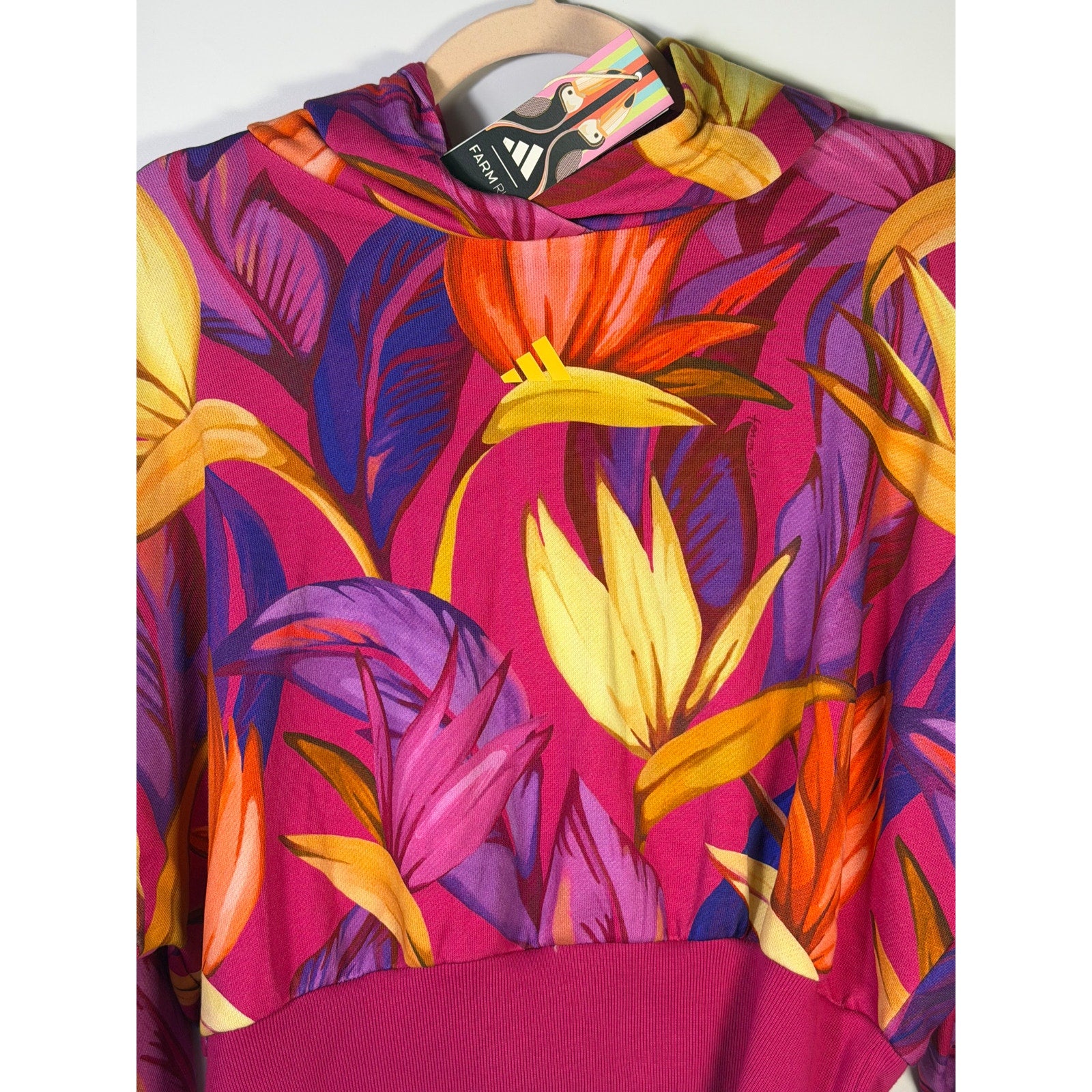 Adidas x FARM Rio women's tropical floral cropped hoodie in pink and multicolor, size XL, with vibrant floral pattern.