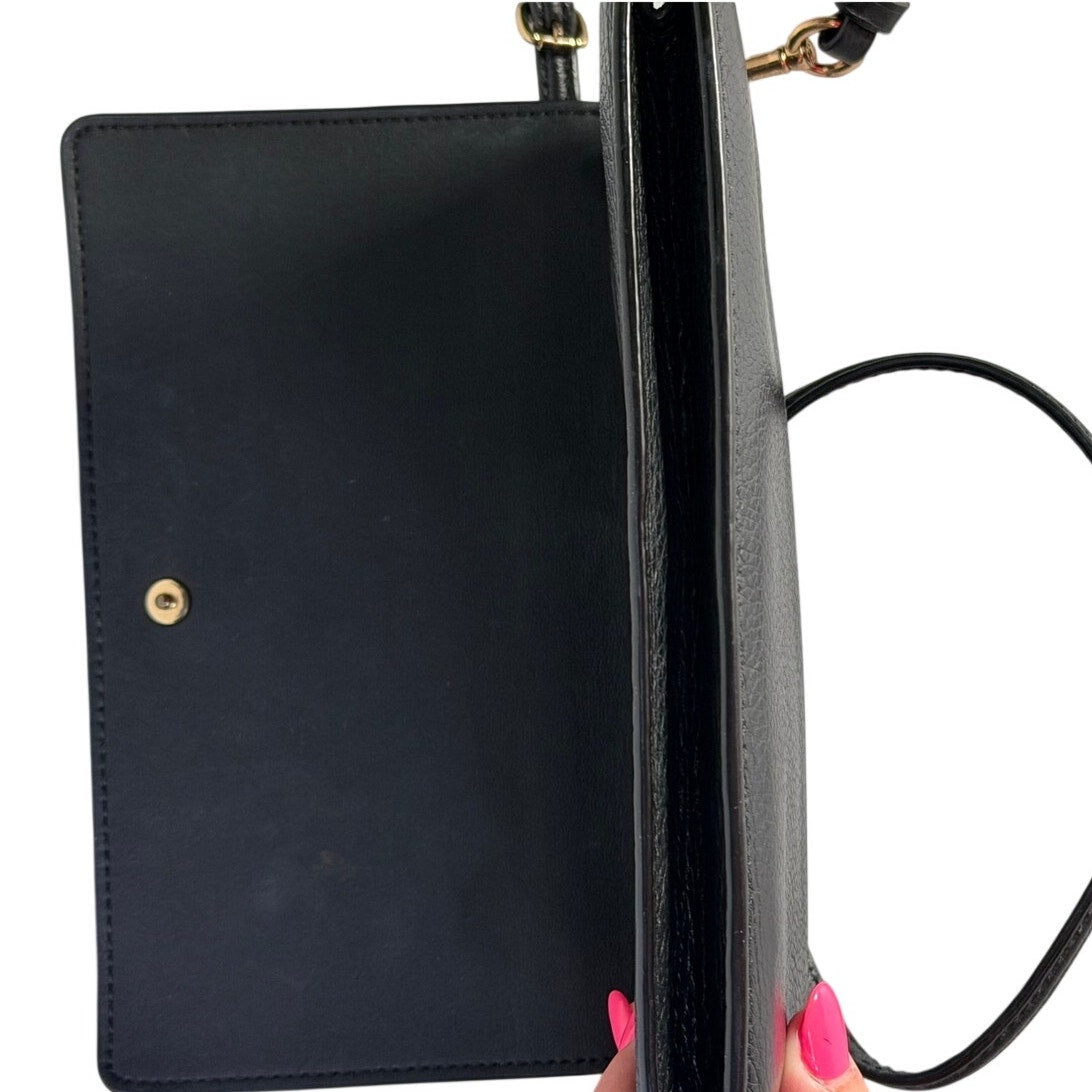 Coach women's black leather foldover crossbody wallet bag with adjustable strap, stylish handbag for everyday use.