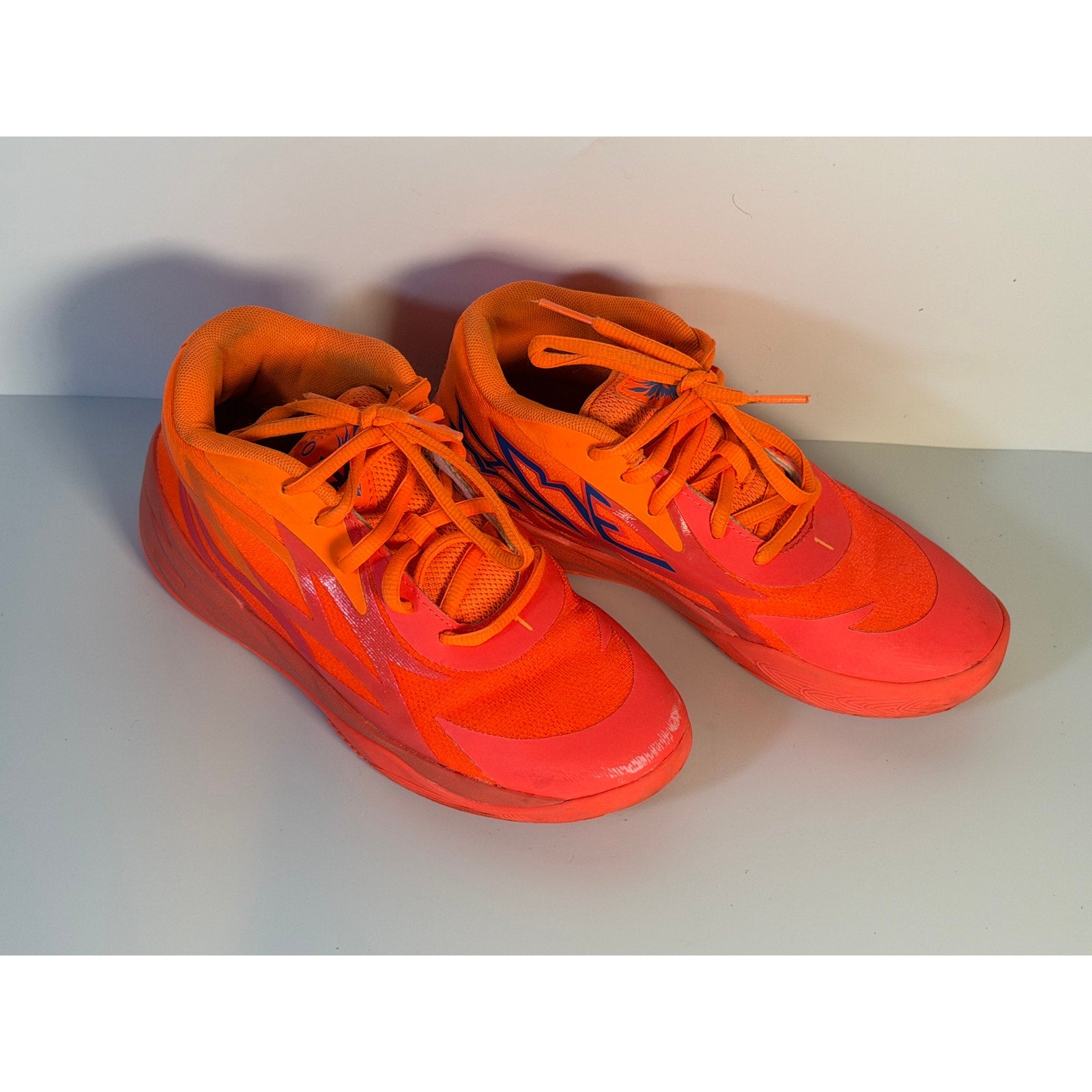 PUMA MB.02 Lo basketball shoes in orange and pink for men, size 5.5, athletic sneakers with a sleek design.