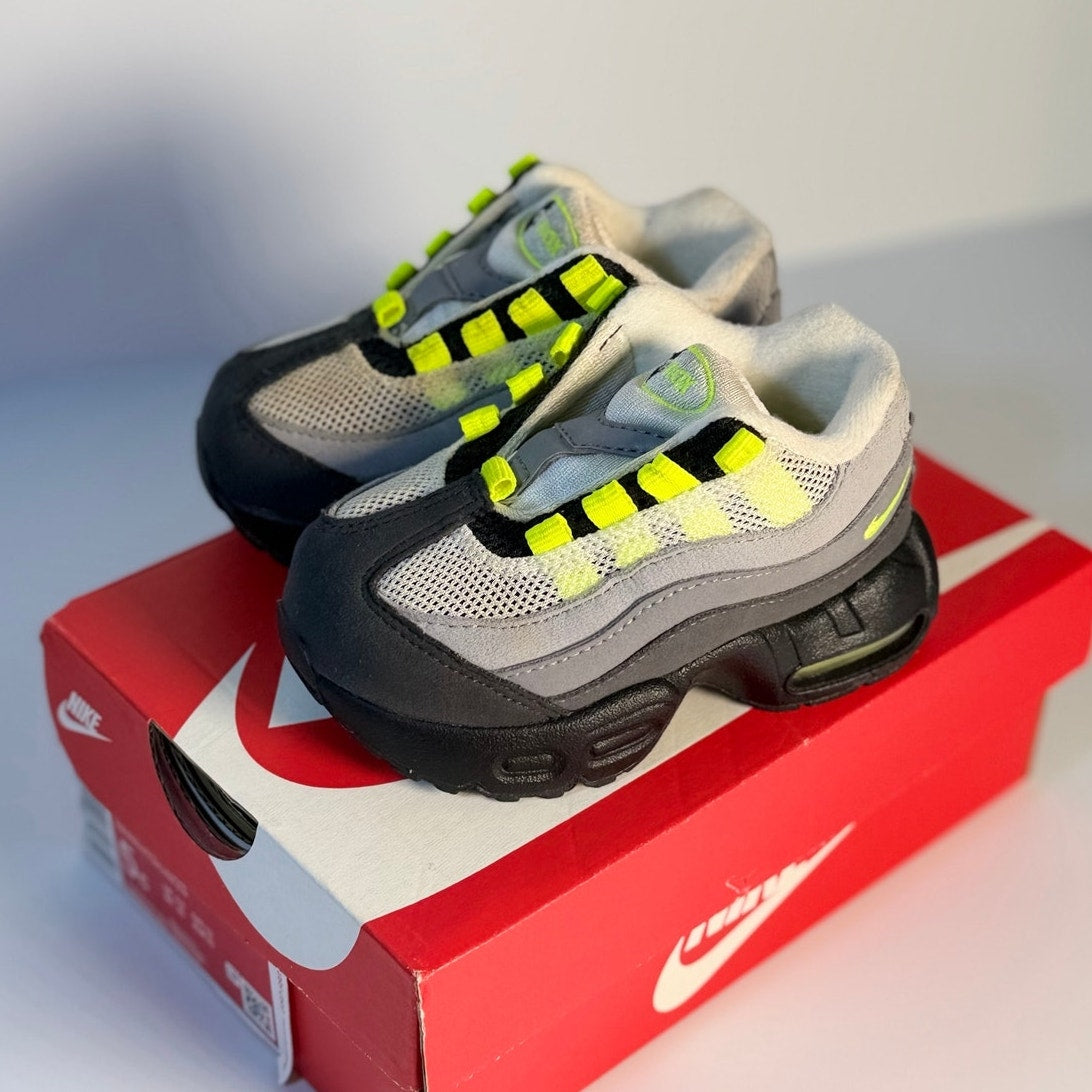 Nike Air Max 95 toddler sneakers in gray, volt, and black, featuring sporty running shoe design for kids.