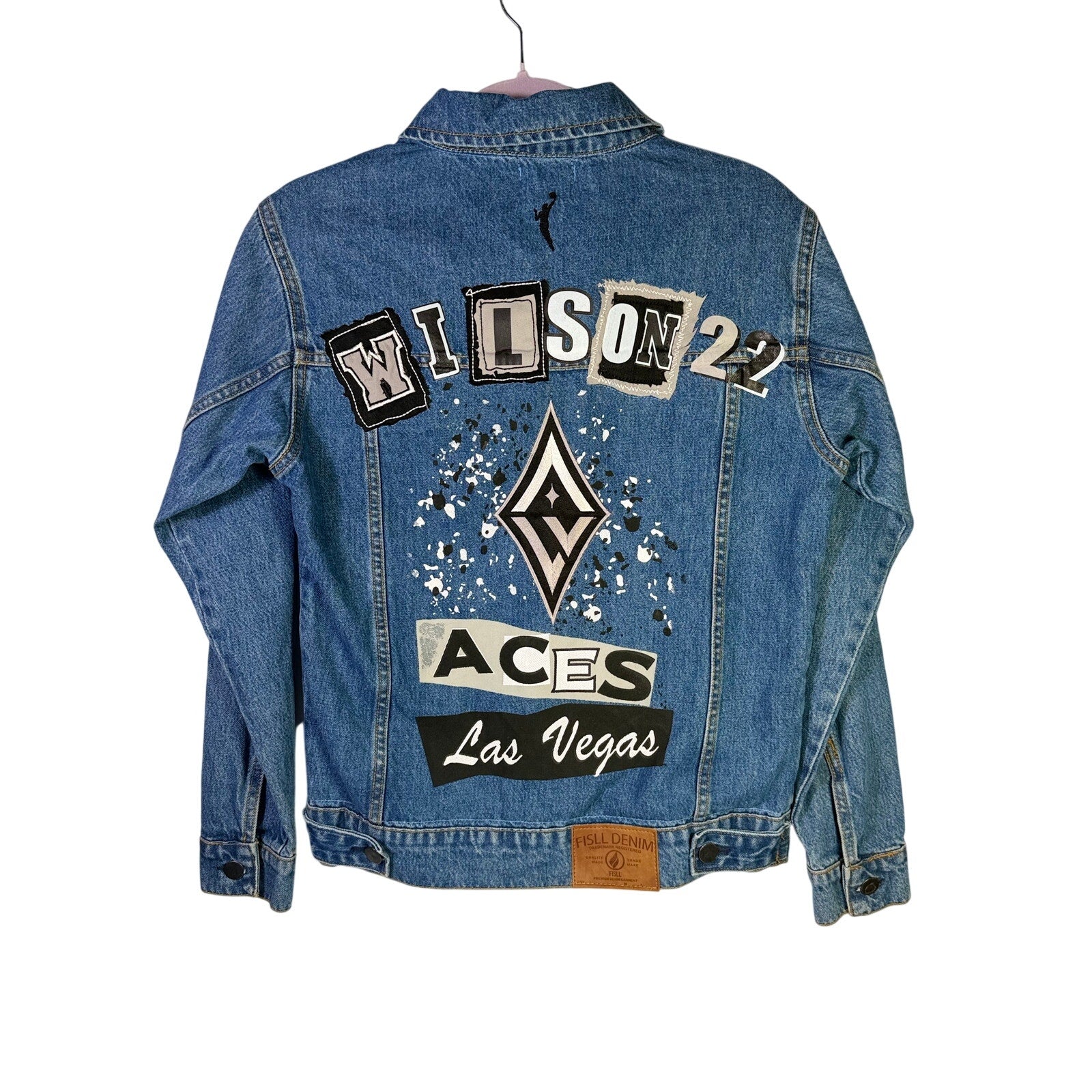 FISLL Las Vegas Aces A’ja Wilson #22 blue denim jacket, size small, shown on a hanger with visible front buttons and classic design.