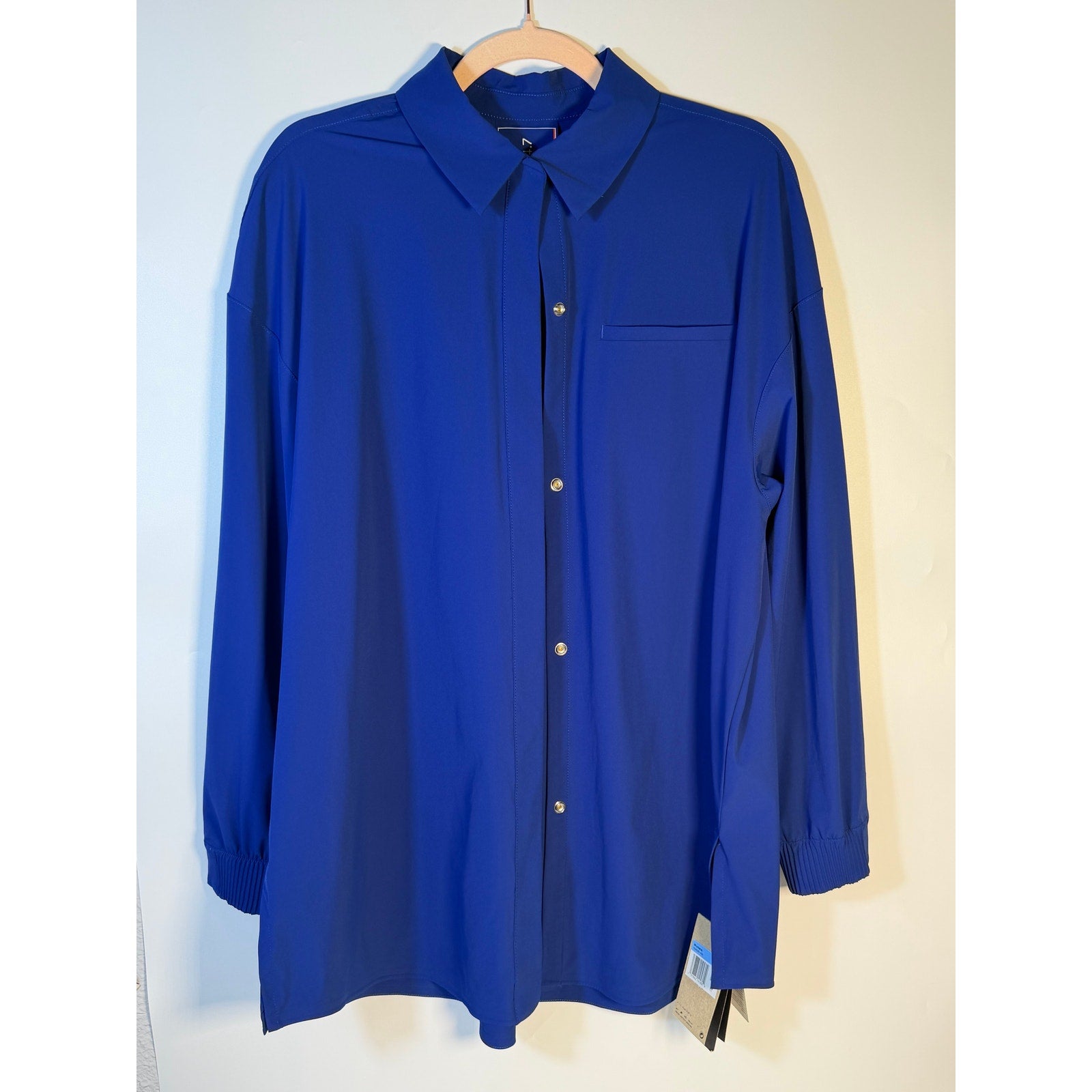 Nike 24.7 Women's medium blue Dri-FIT training button front shirt, lightweight athletic top with short sleeves and athletic fit.