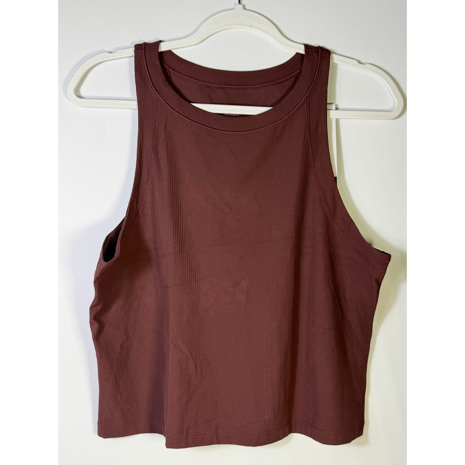Nike women's brown ribbed cropped muscle tank top, size large, showing the fitted design and ribbed texture.