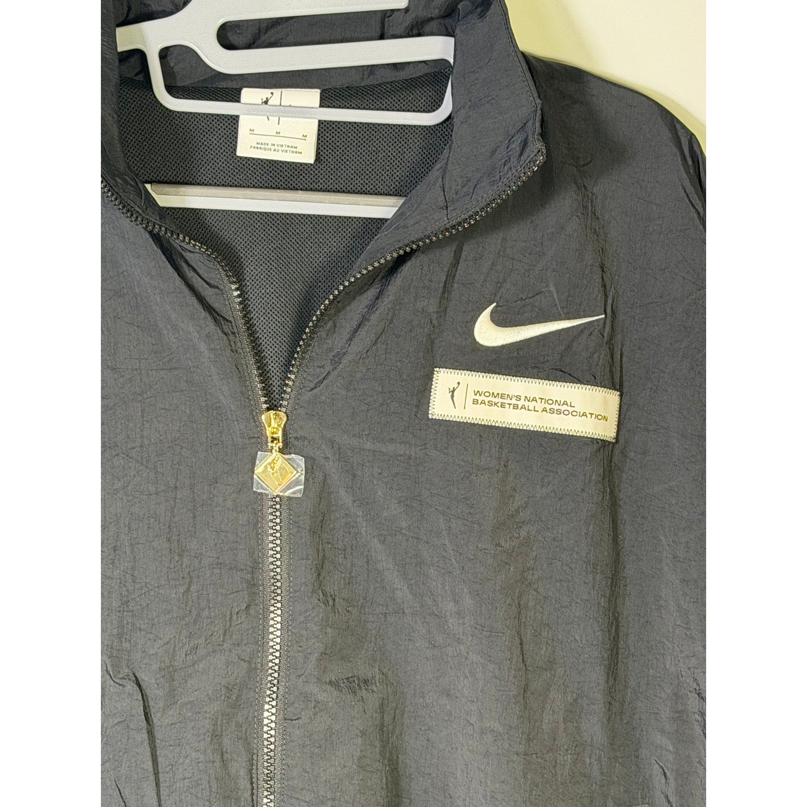 Nike women's WNBA black windbreaker jacket with full zip, mesh lining, size M, lightweight and sporty outerwear.