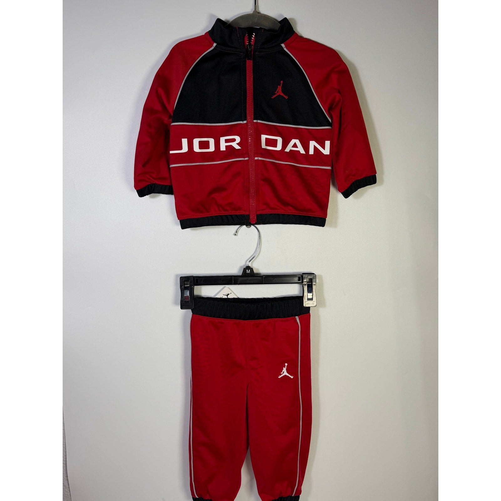 Jordan baby boys 2-piece tracksuit jacket and pants in red and black, size 12 months, new with tags.