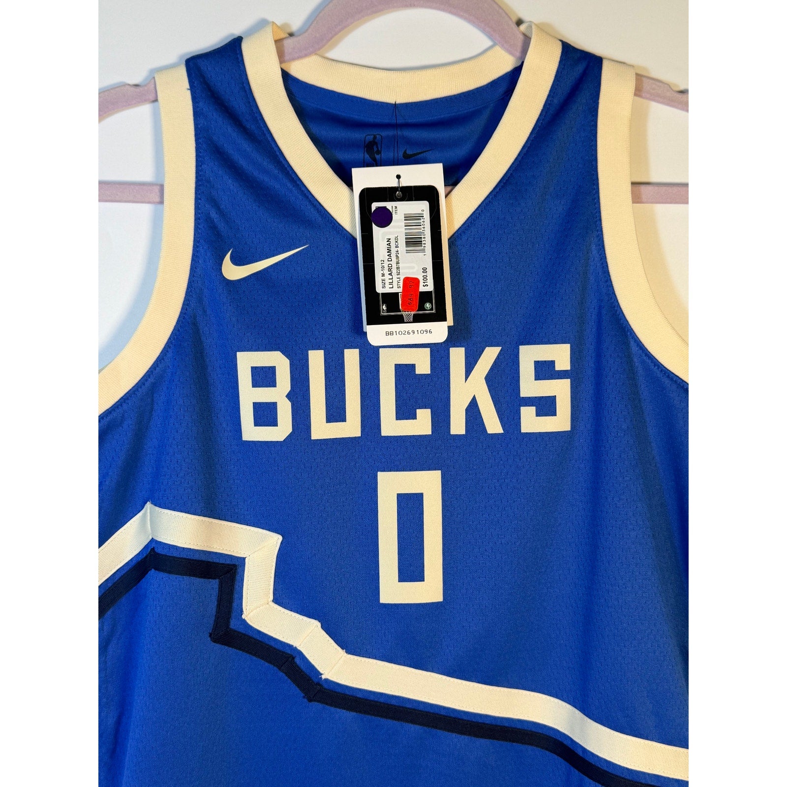 Nike Milwaukee Bucks Damian Lillard #0 City Edition youth jersey, size M, featuring team logo and vibrant Bucks colors.