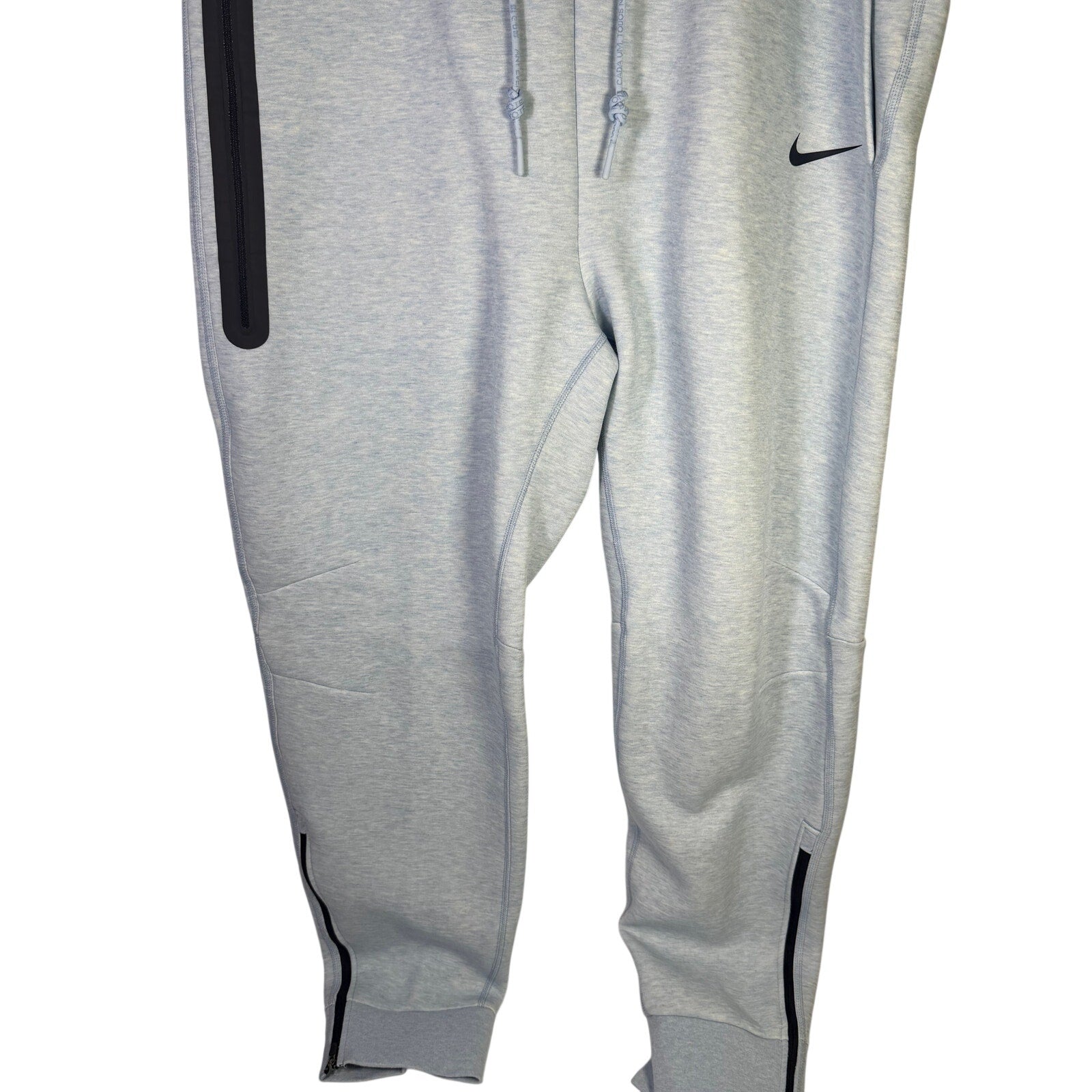 Nike Sportswear Tech Fleece jogger pants for men in light blue heather, featuring a relaxed fit and athletic style.