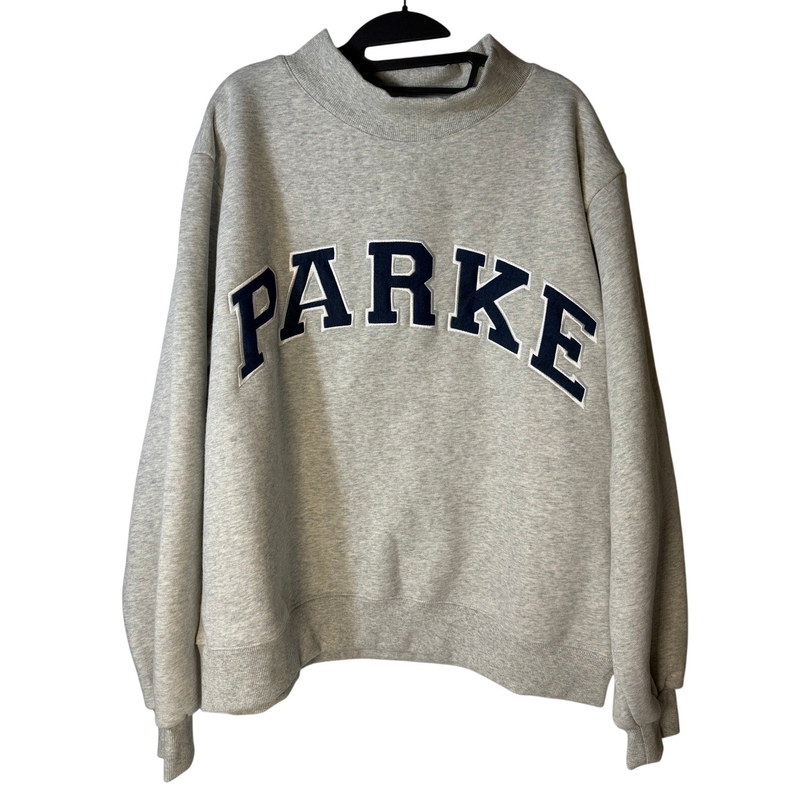 Women's gray PARKE oversized fleece sweatshirt with mock neck, embroidered logo, and relaxed fit.