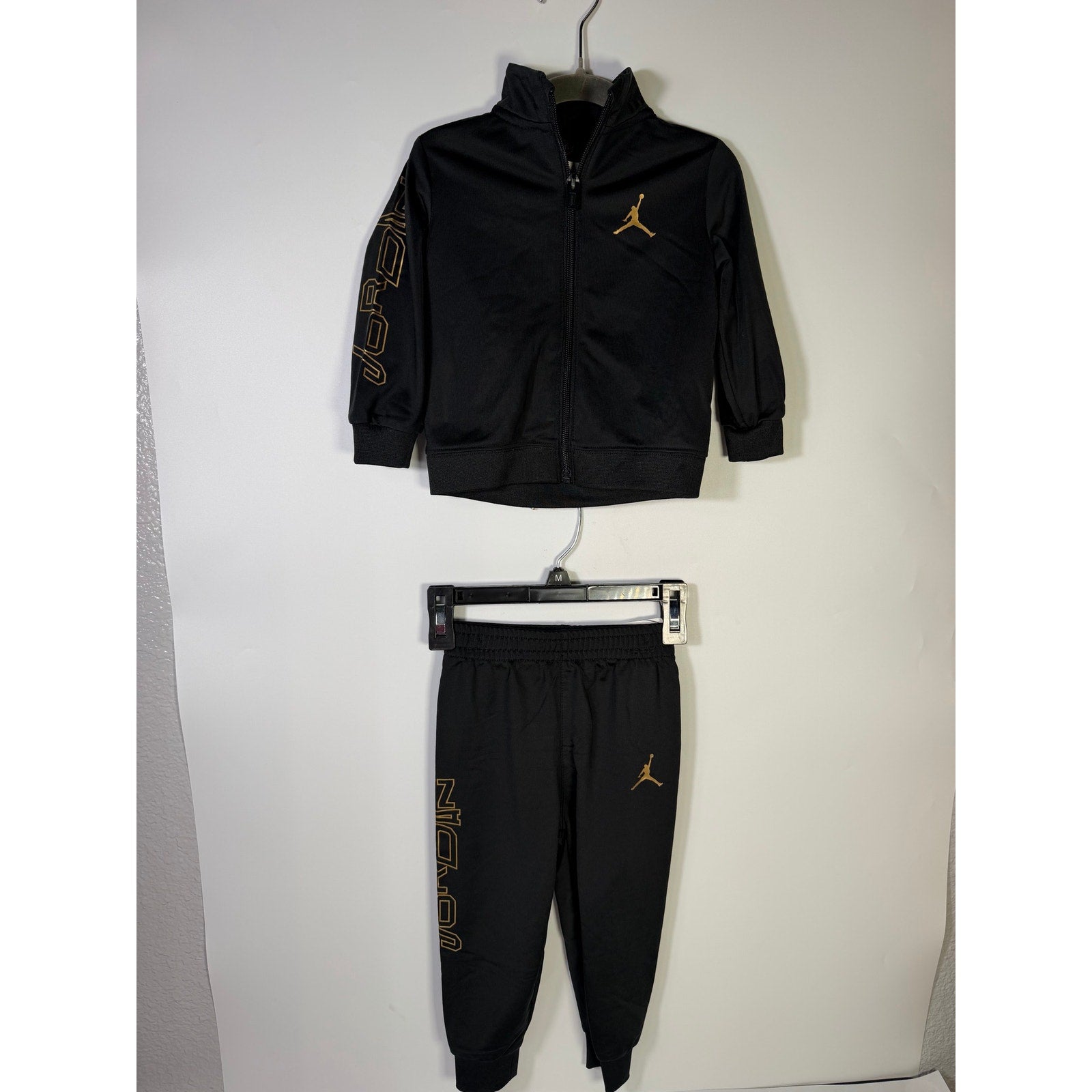 Jordan baby boys 2-piece black and gold track jacket and jogger set, size 18 months, new with tags.