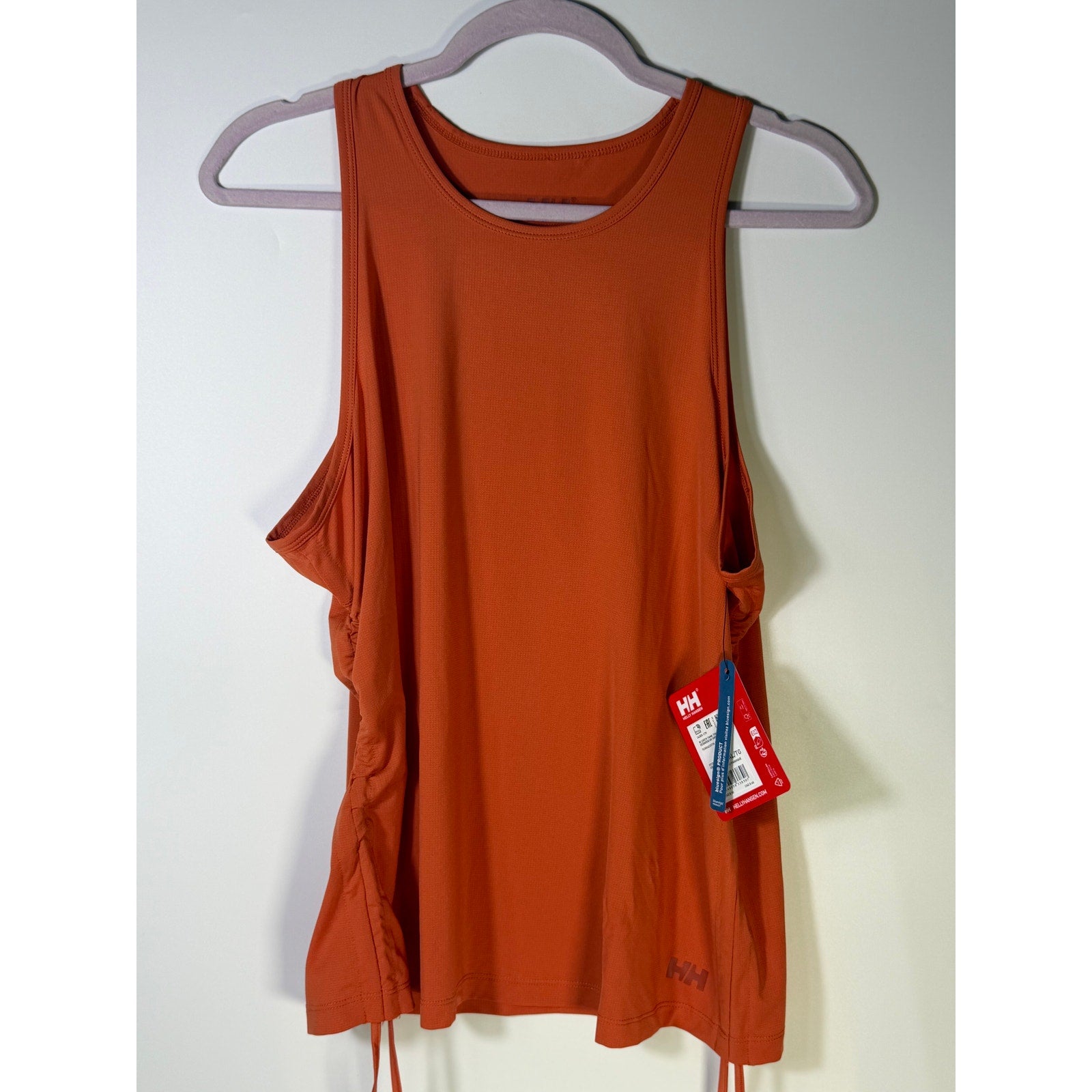 Helly Hansen women's orange active tank top with sleeveless design and drawstring hem, suitable as a sports bra, size XL.