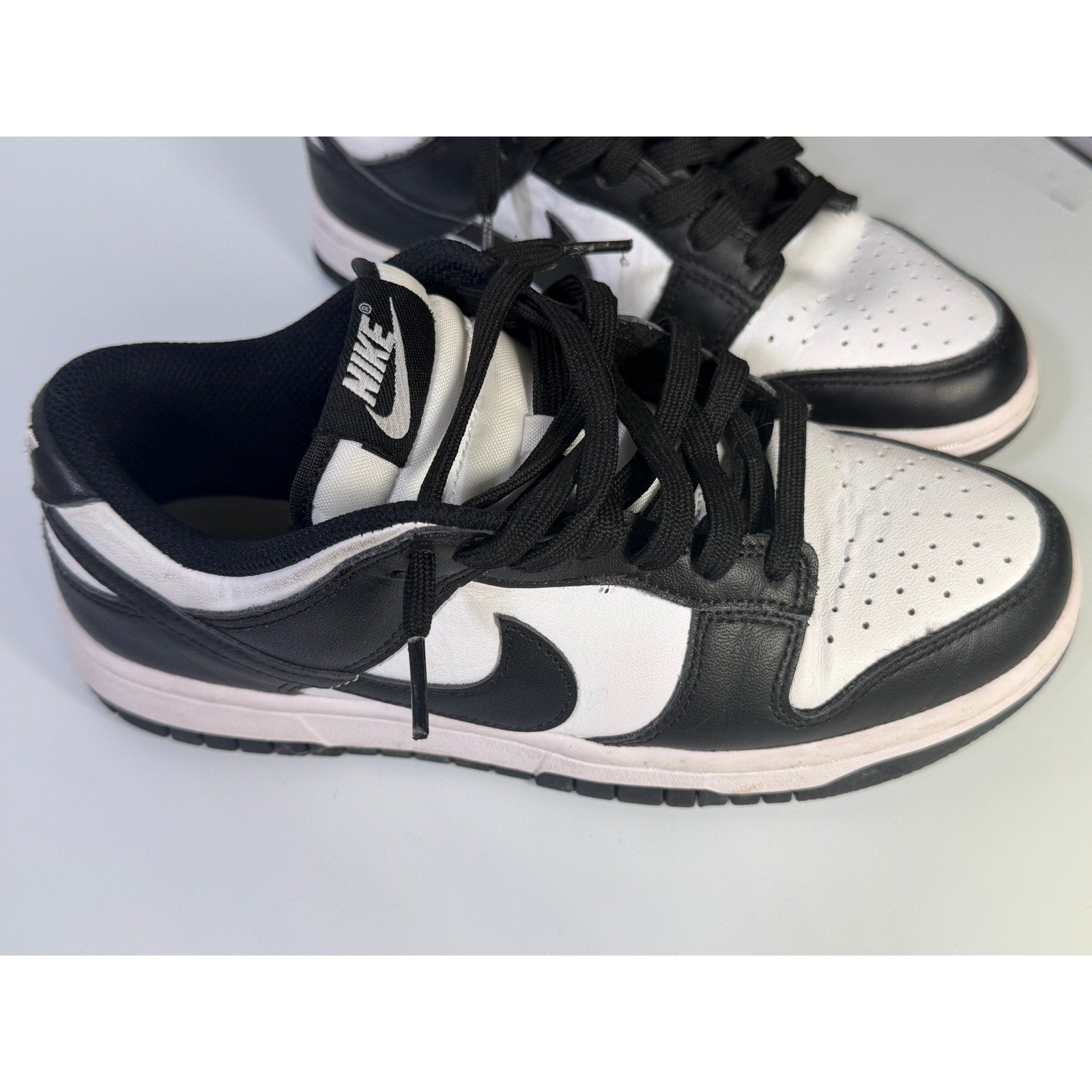 Nike Dunk Low Panda sneakers in youth size 5Y, black and white with a low-top design and Nike branding.