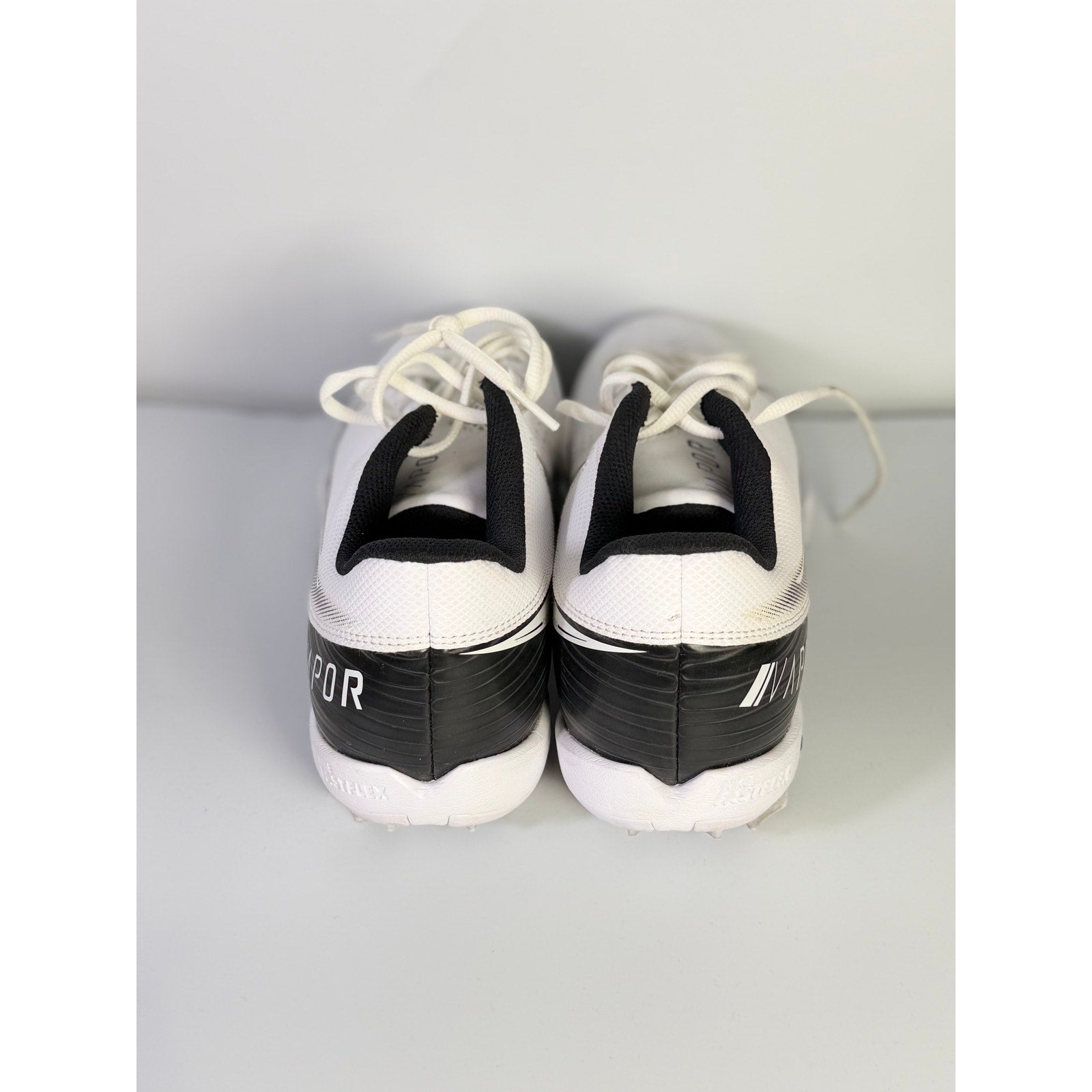 Nike Vapor football cleats in white and black, men's size 8.5, with lightweight design and textured sole for optimal grip.
