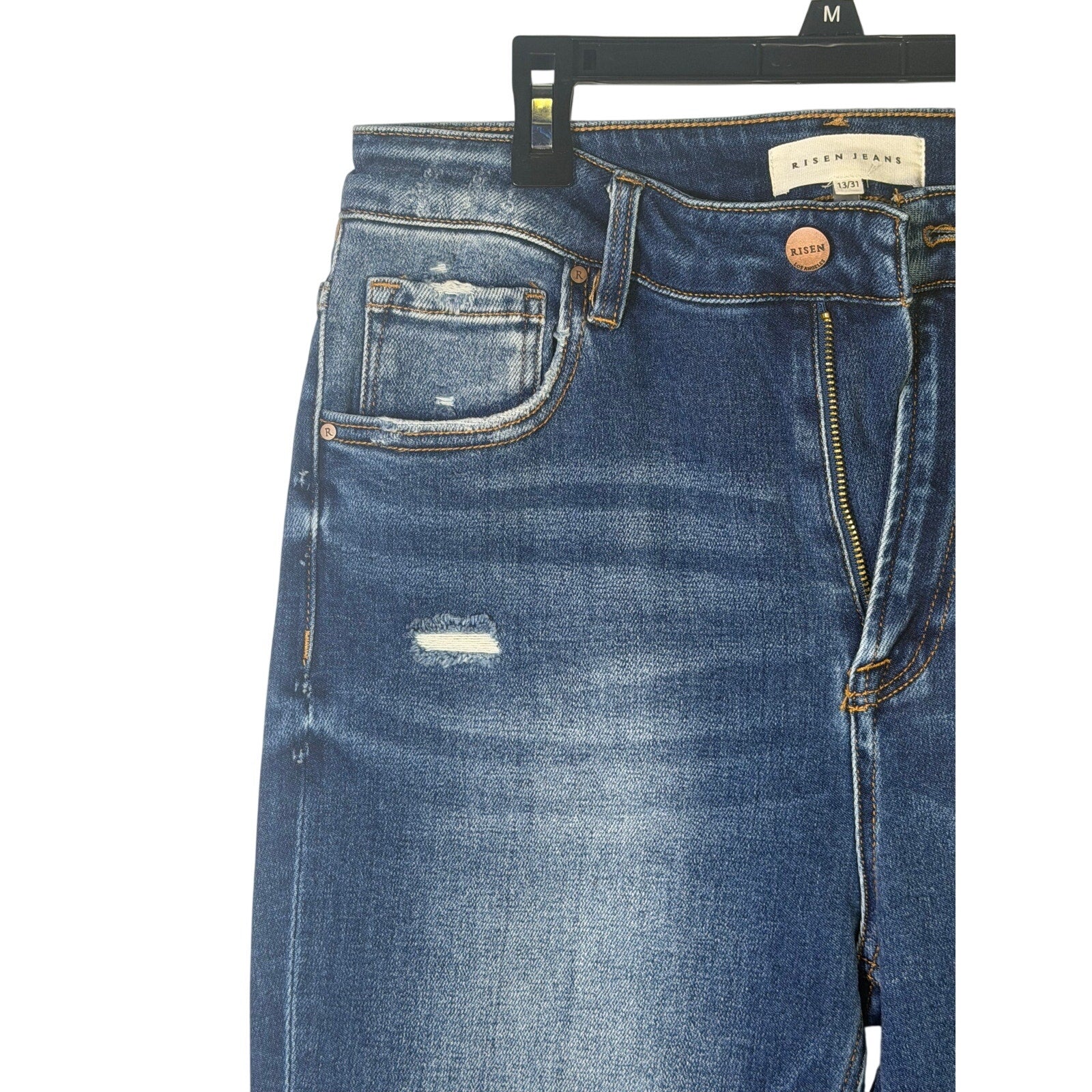 Risen Jeans women's size 13/31 dark wash distressed flare jeans showing front view with frayed hem and classic five-pocket design.