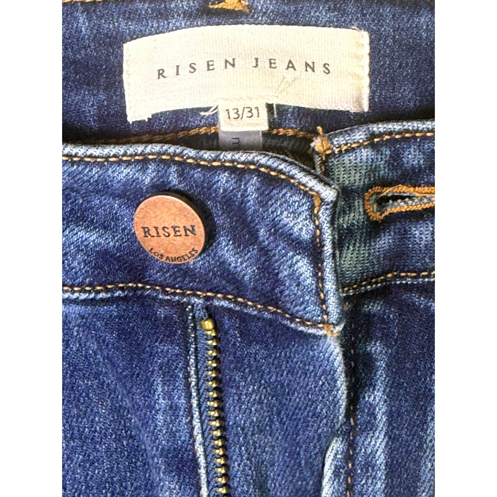 Risen Jeans women's size 13/31 dark wash distressed flare jeans, with a high-rise fit and frayed hem detail.