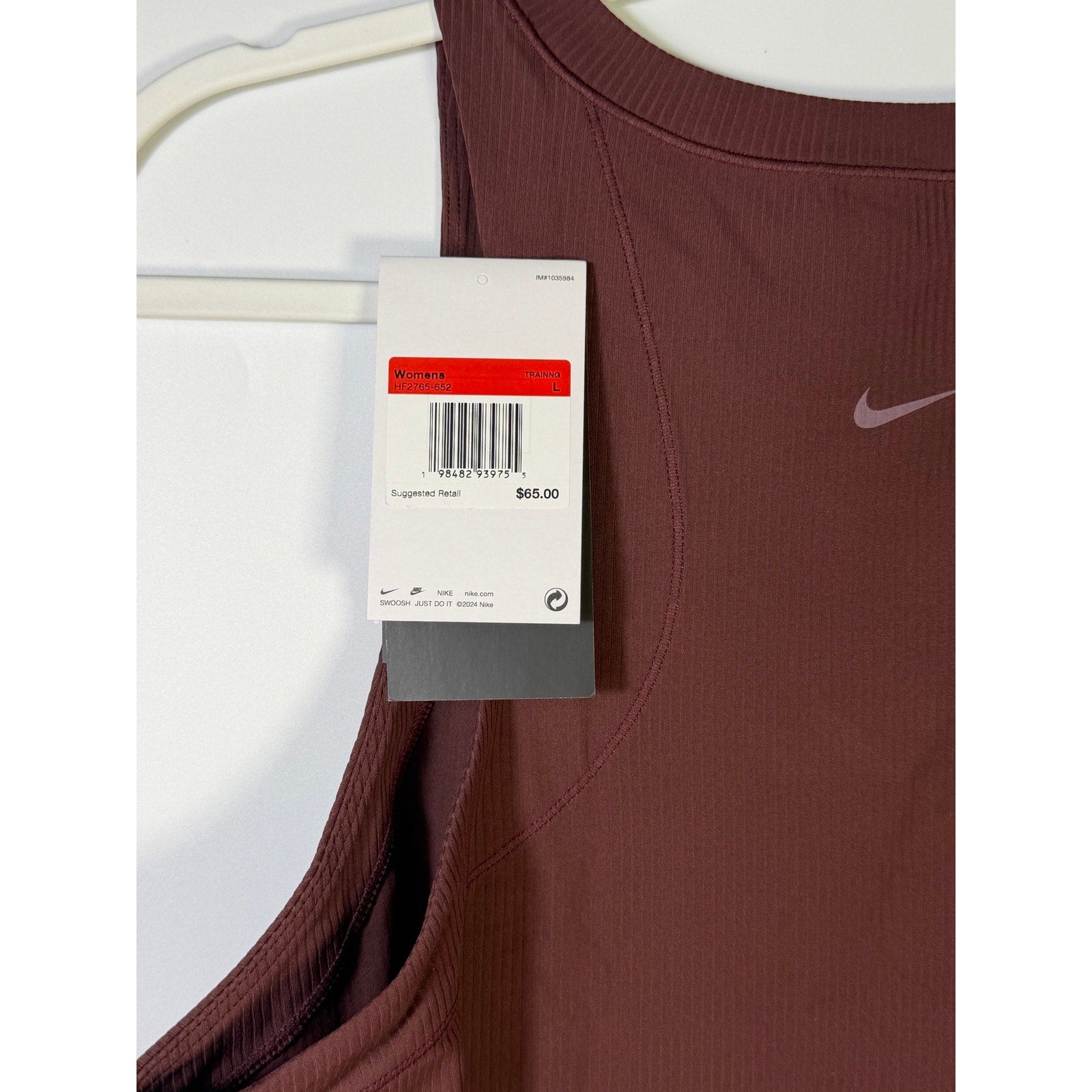 Nike women's ribbed cropped muscle tank top in brown, size large, featuring a fitted sleeveless design for athletic or casual wear.