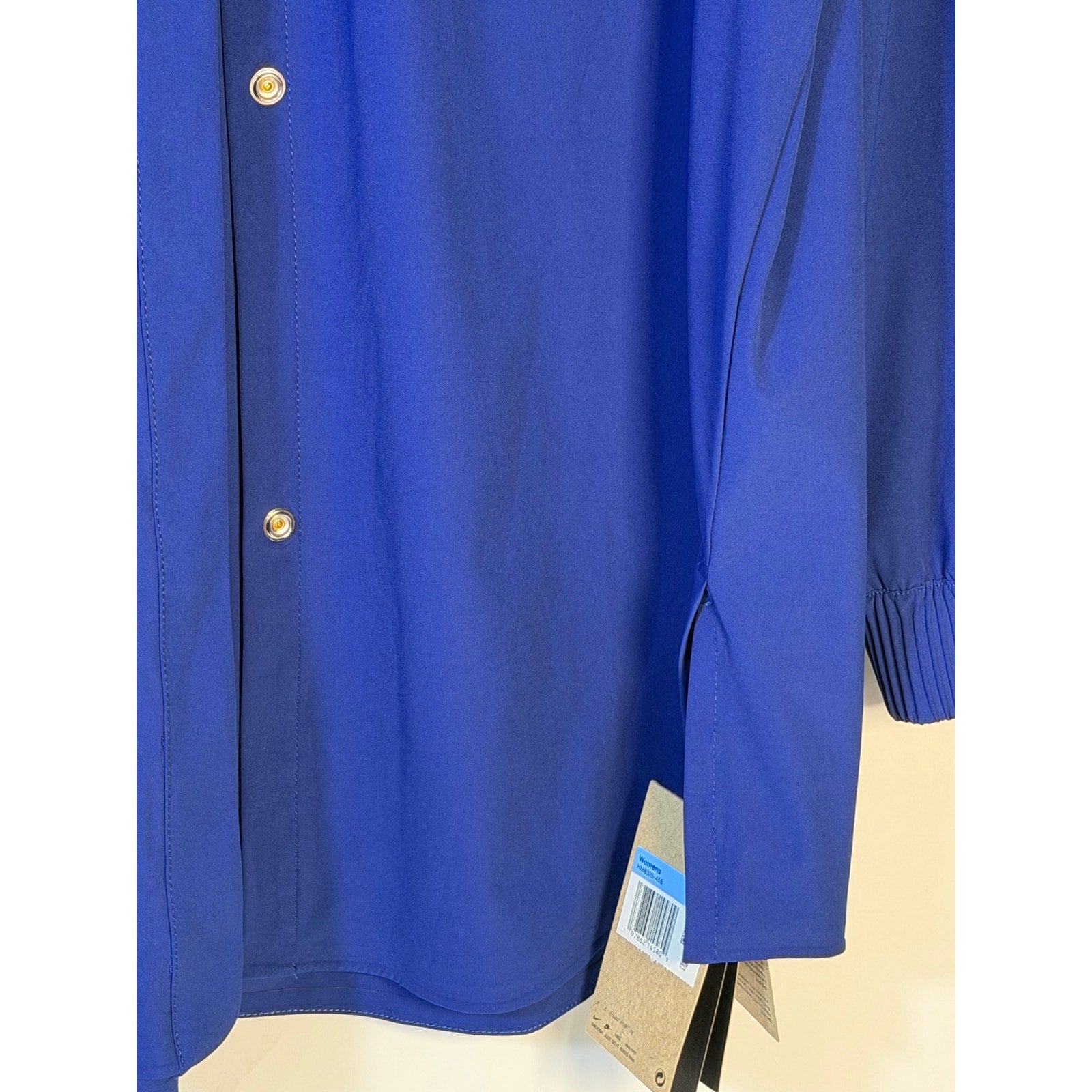 Nike 24.7 Women's Medium Blue Dri-FIT training button-front shirt, lightweight athletic top with short sleeves and breathable fabric.